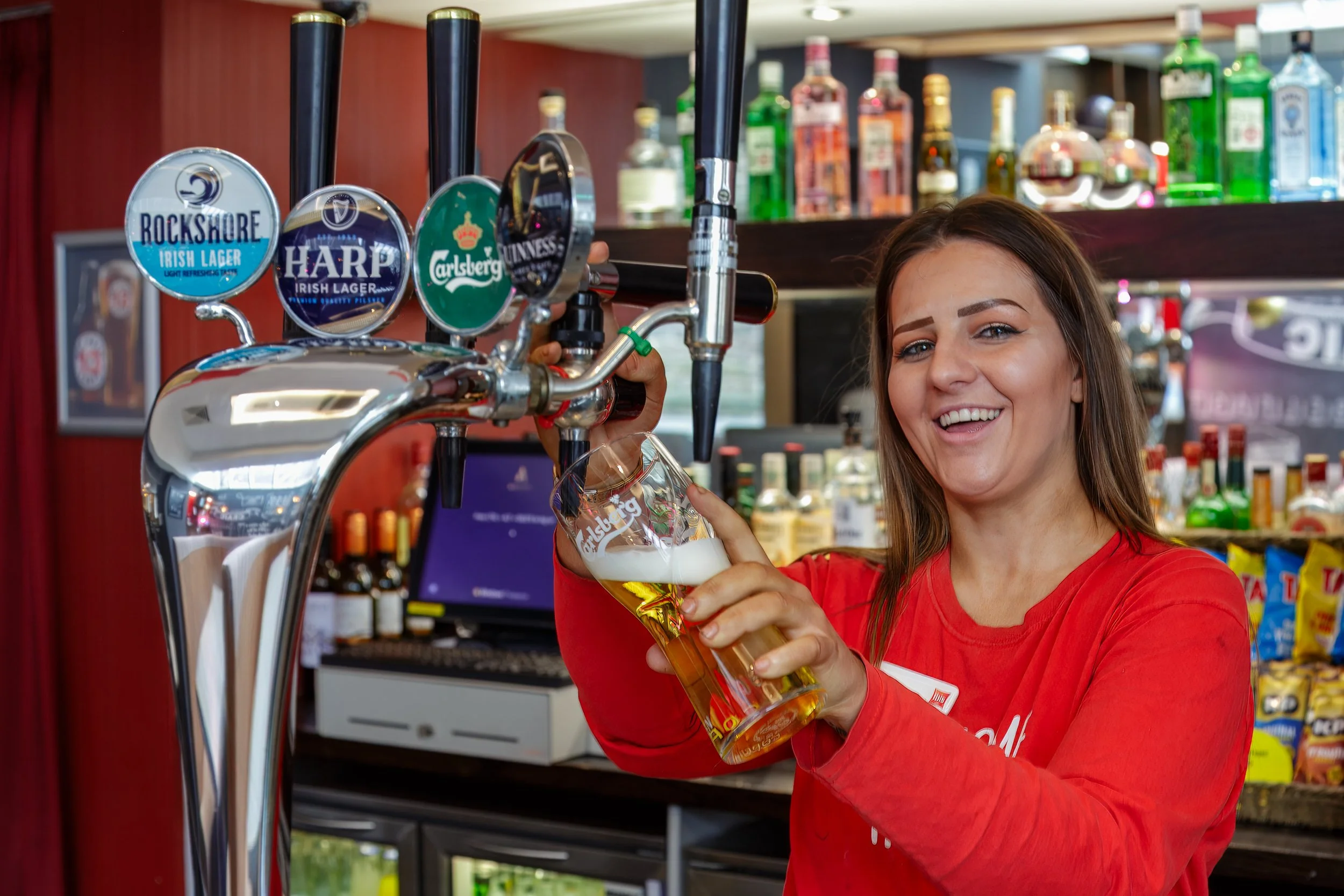 smiling-female-bartender-pulling-pint-lager-ibis-hotel-belfast.jpg