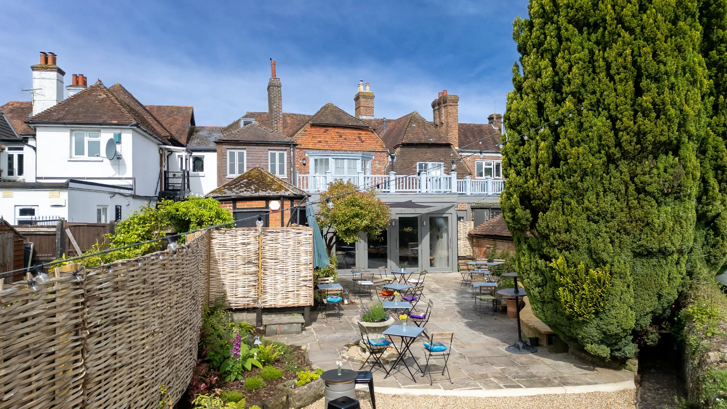 Slightly elevated wide shot of exterior enclosed courtyard – The Lion's Den Midhurst – Hospitality Venue Photography by Sequoia Studios