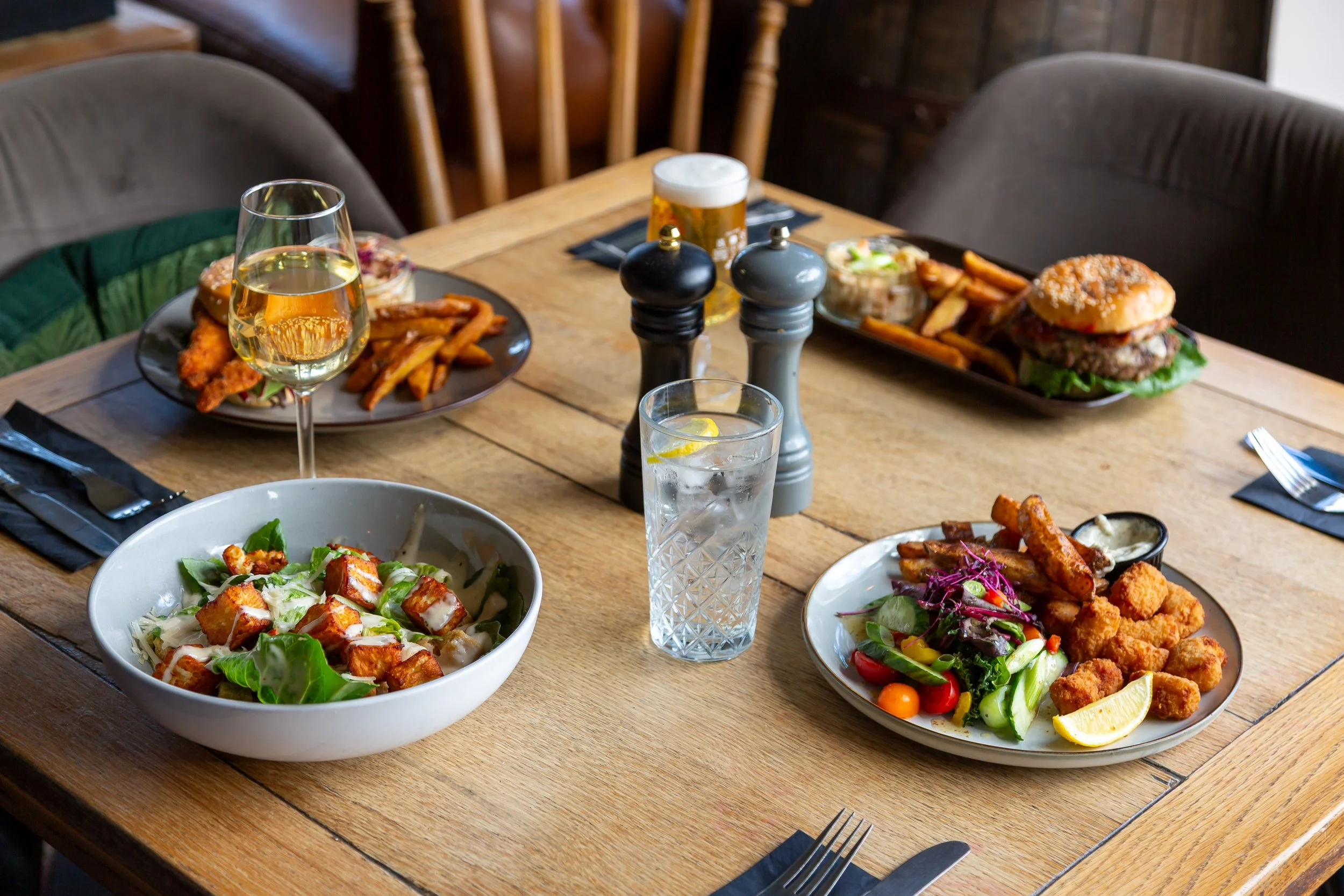Meals and drinks on table for The Folly Lunch Club in Petersfield, Hampshire. Food photography by Sequoia Studios.