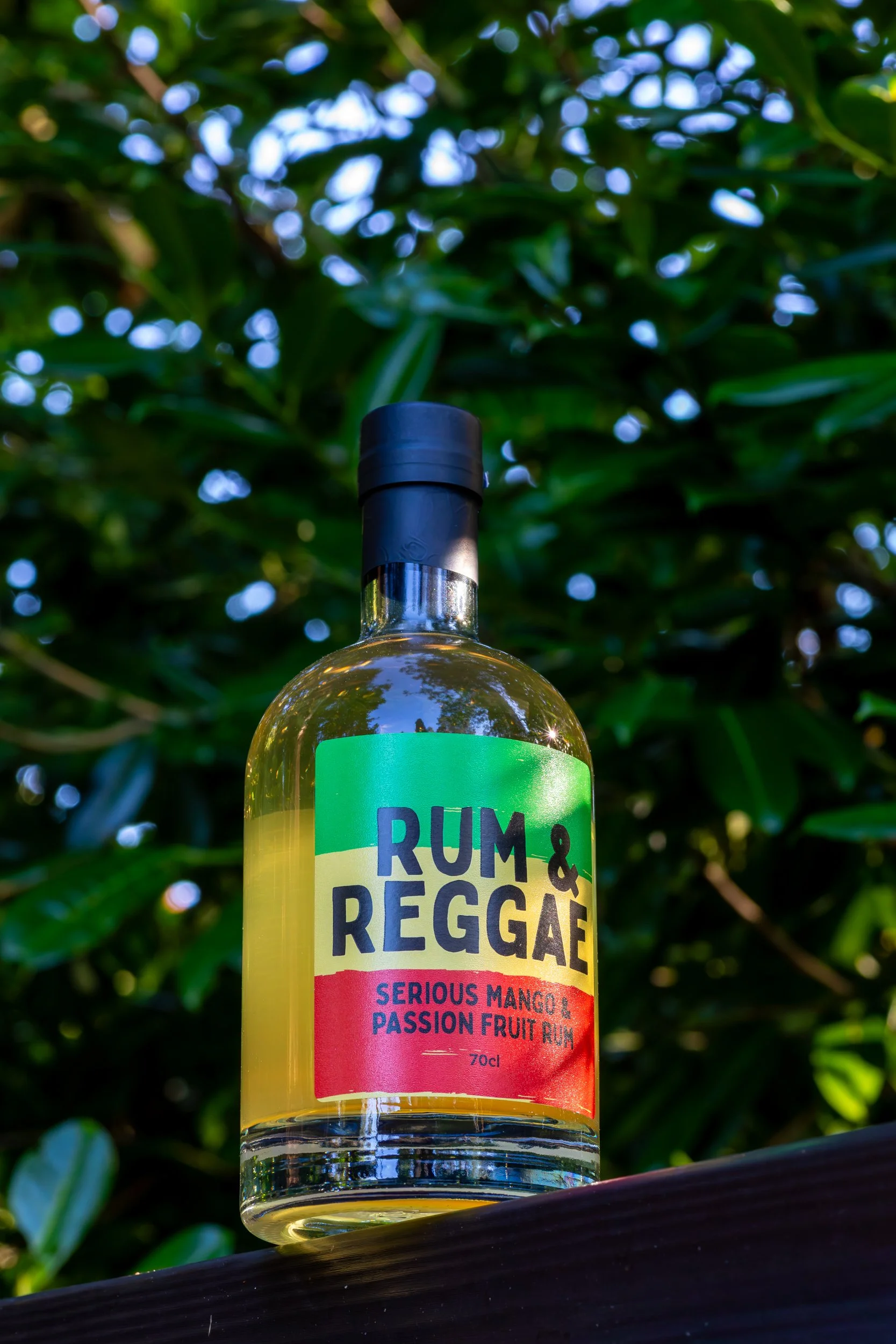 Rum &amp; Reggae Serious Mango &amp; Passion Fruit Rum product shot against green foliage