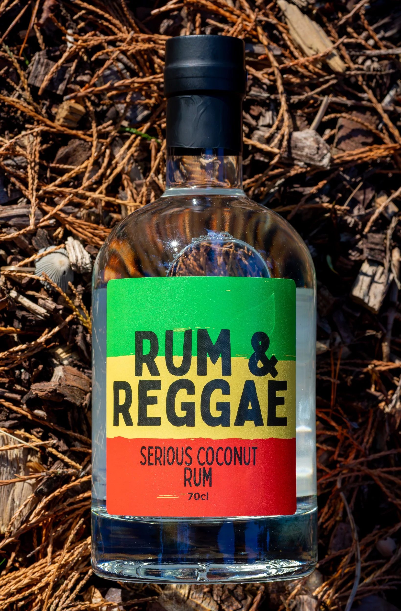 Rum &amp; Reggae Serious Coconut Rum product shot on fallen pine needles