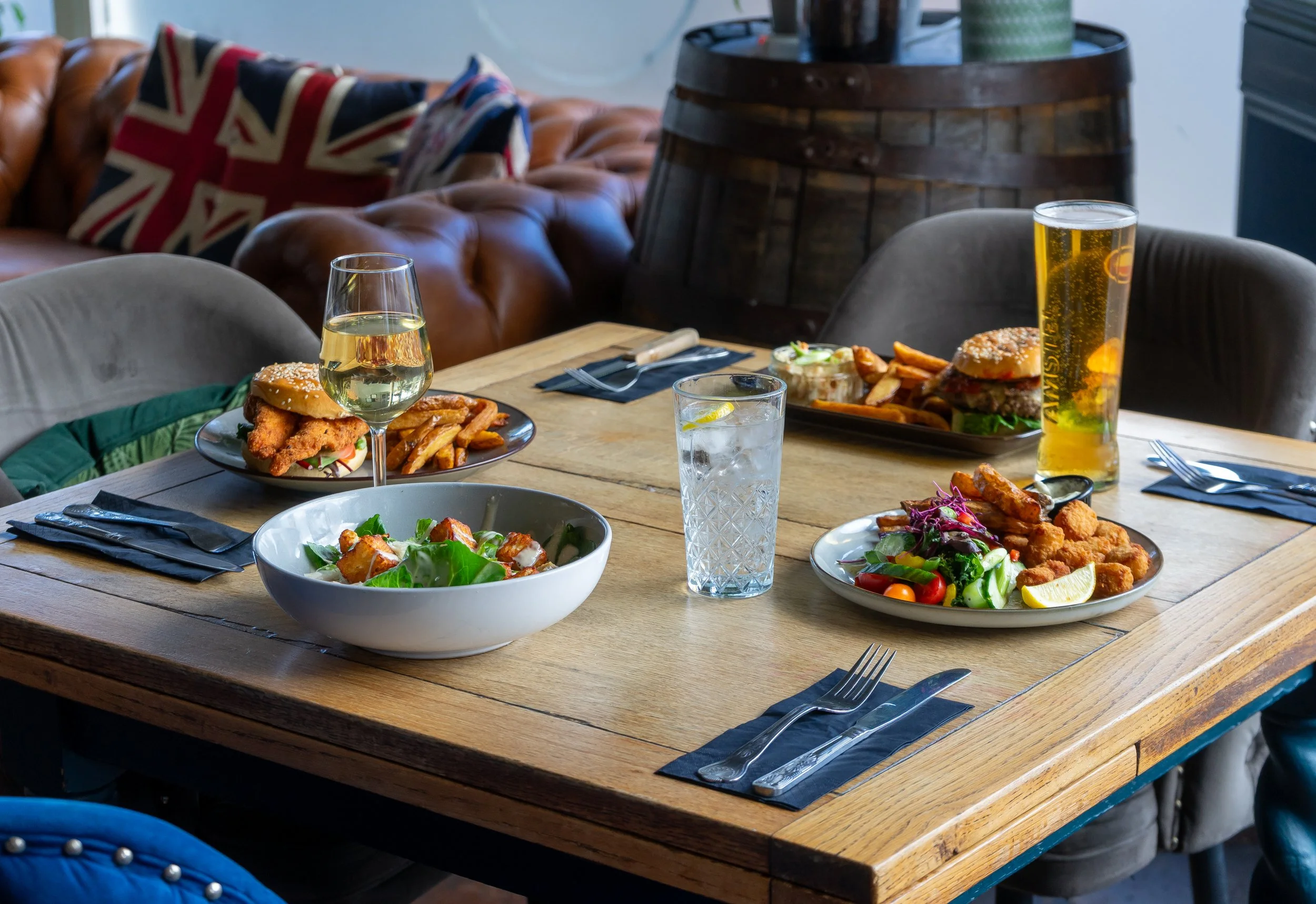 Four meals and drinks on table for The Folly Lunch Club in Petersfield, Hampshire. Lifestyle photography by Sequoia Studios.