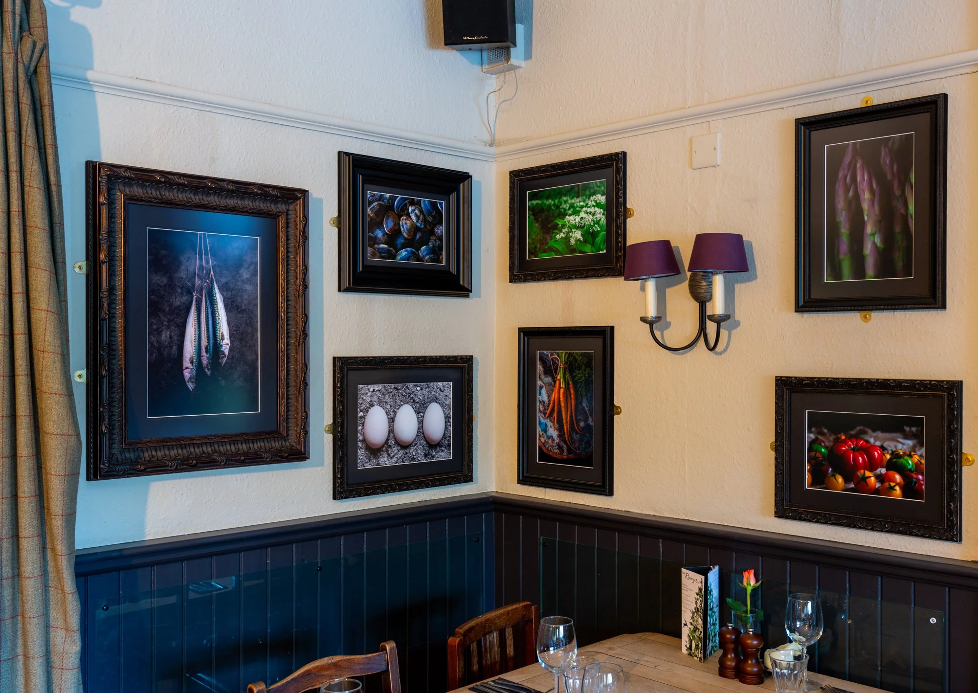 Corner shot of the bespoke photographic artwork on the dining room walls at The Rising Sun Milland