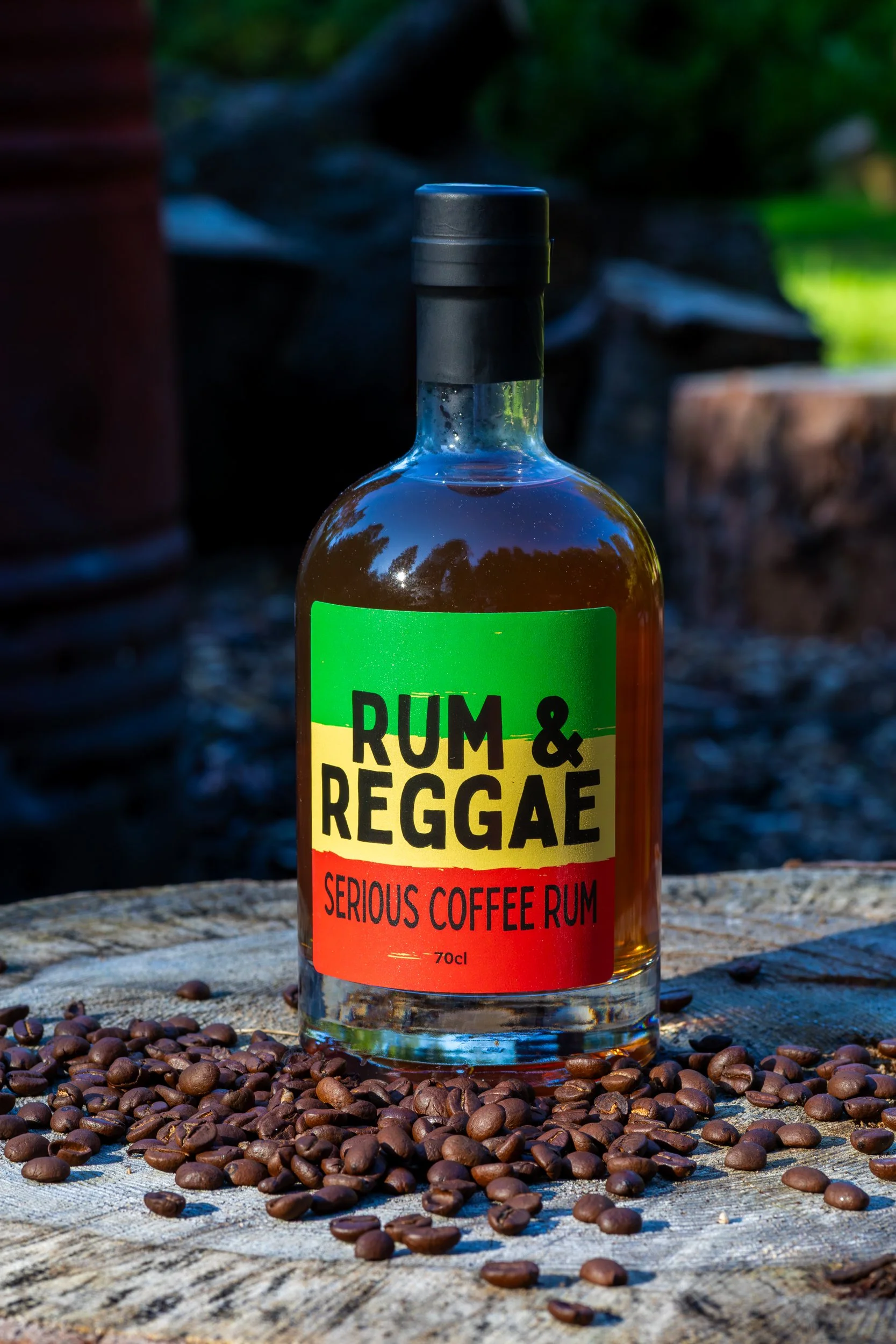 Rum &amp; Reggae Serious Coffee Rum product shot on tree stump with coffee beans