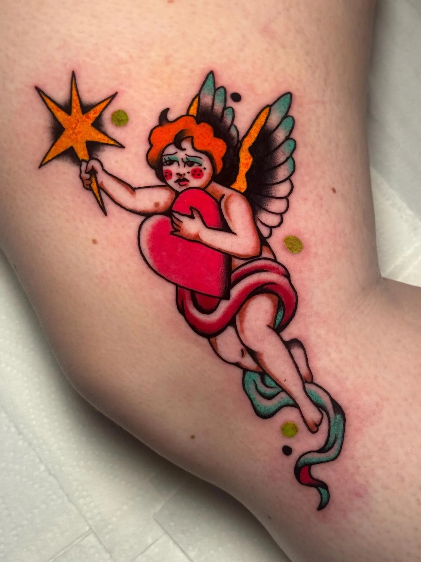 Custom diva cherub, Jamiel, for Talisha who braved my least favorite place I have  ever been tattooed on 😂 thanks for hanging in there pal 🌈

🗓️ Booking for: July &amp; Beyond 🪩✨

🌻 home base: @kingscrosstattoo
💖 custom requests welcome
🎱 100&