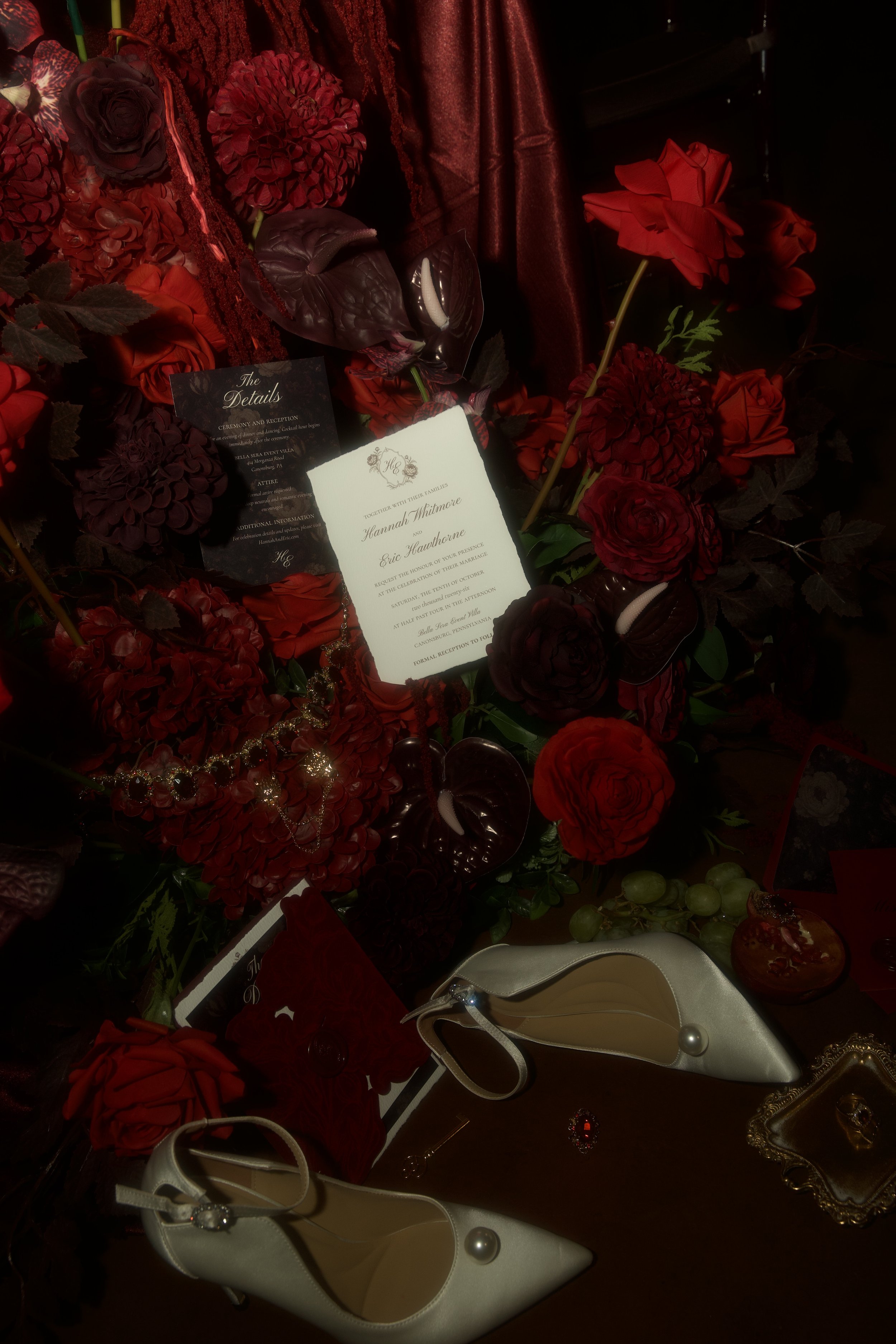 A dramatic wedding staircase floral installation featuring deep red roses, burgundy blooms, cascading amaranthus, and layered candlelight. Designed by S.R. Event Design & Decor for a dark romance styled shoot at Bella Sera Event Villa near Pittsburgh