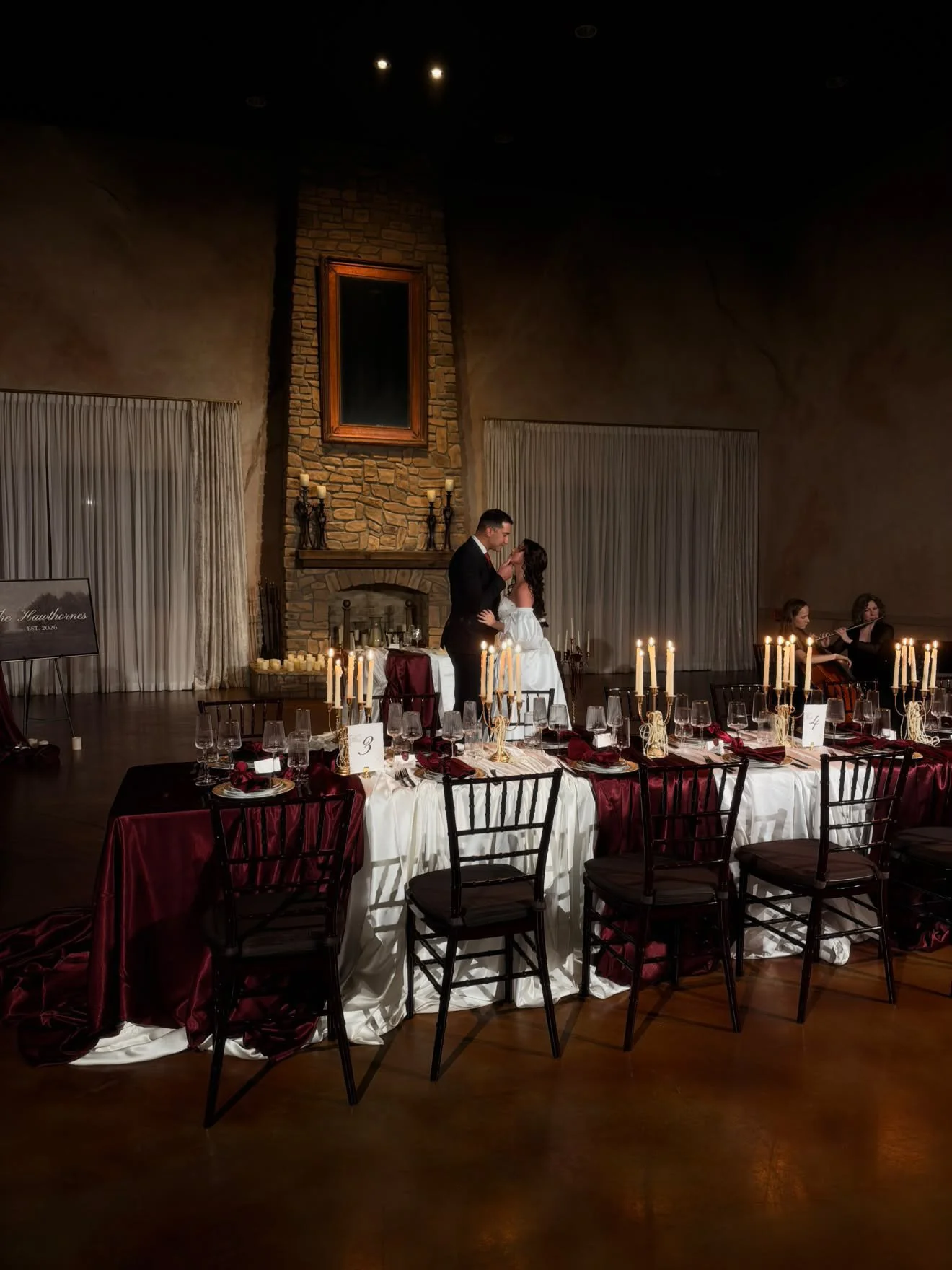 A dramatic floral installation featuring deep red roses, burgundy blooms, cascading amaranthus, and layered candlelight. Designed by S.R. Event Design & Decor for a dark romance styled shoot at Bella Sera Event Villa near Pittsburgh, this statement a