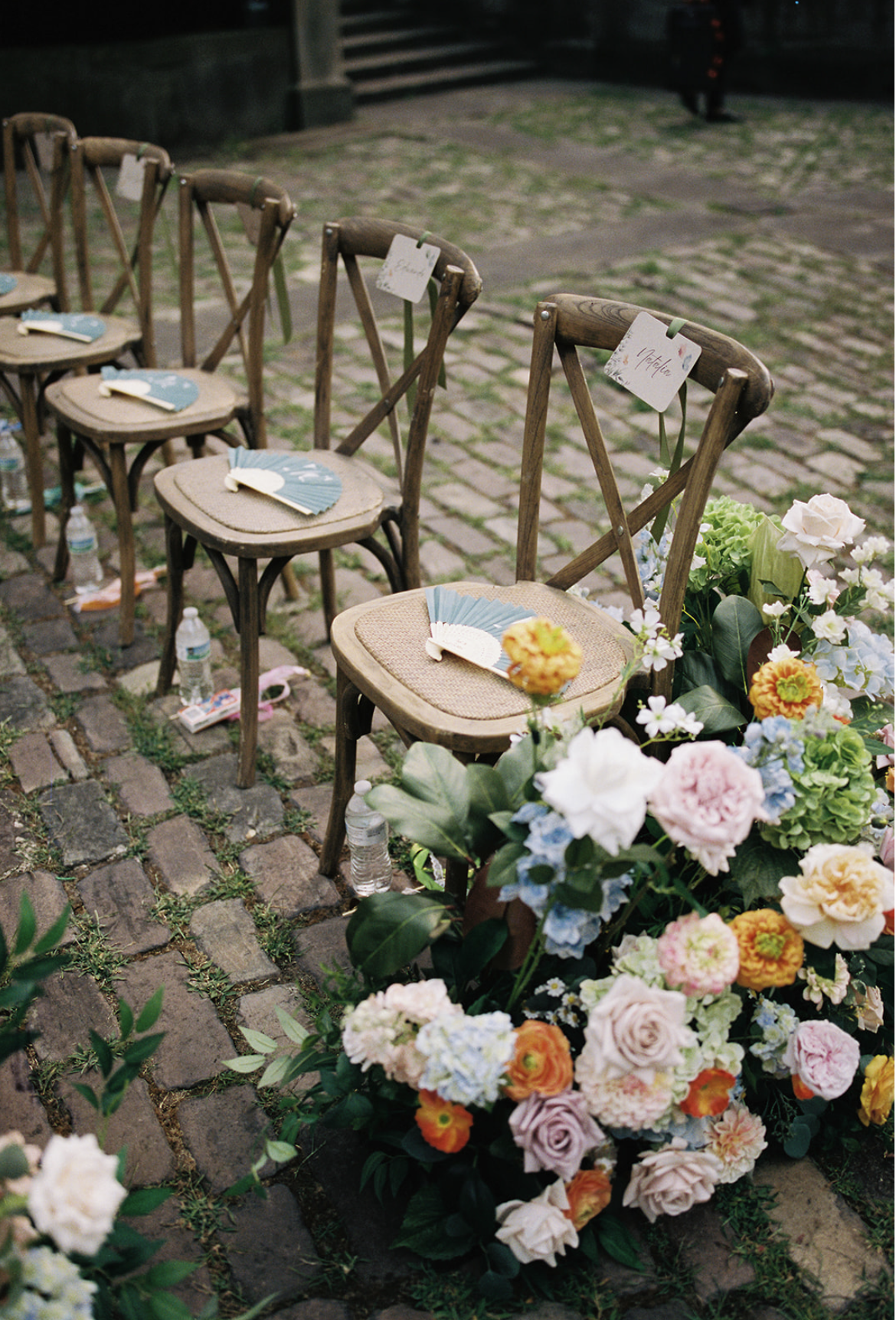 A picture-perfect Cleveland wedding ceremony framed by premium silk flowers and a historic garden fountain 