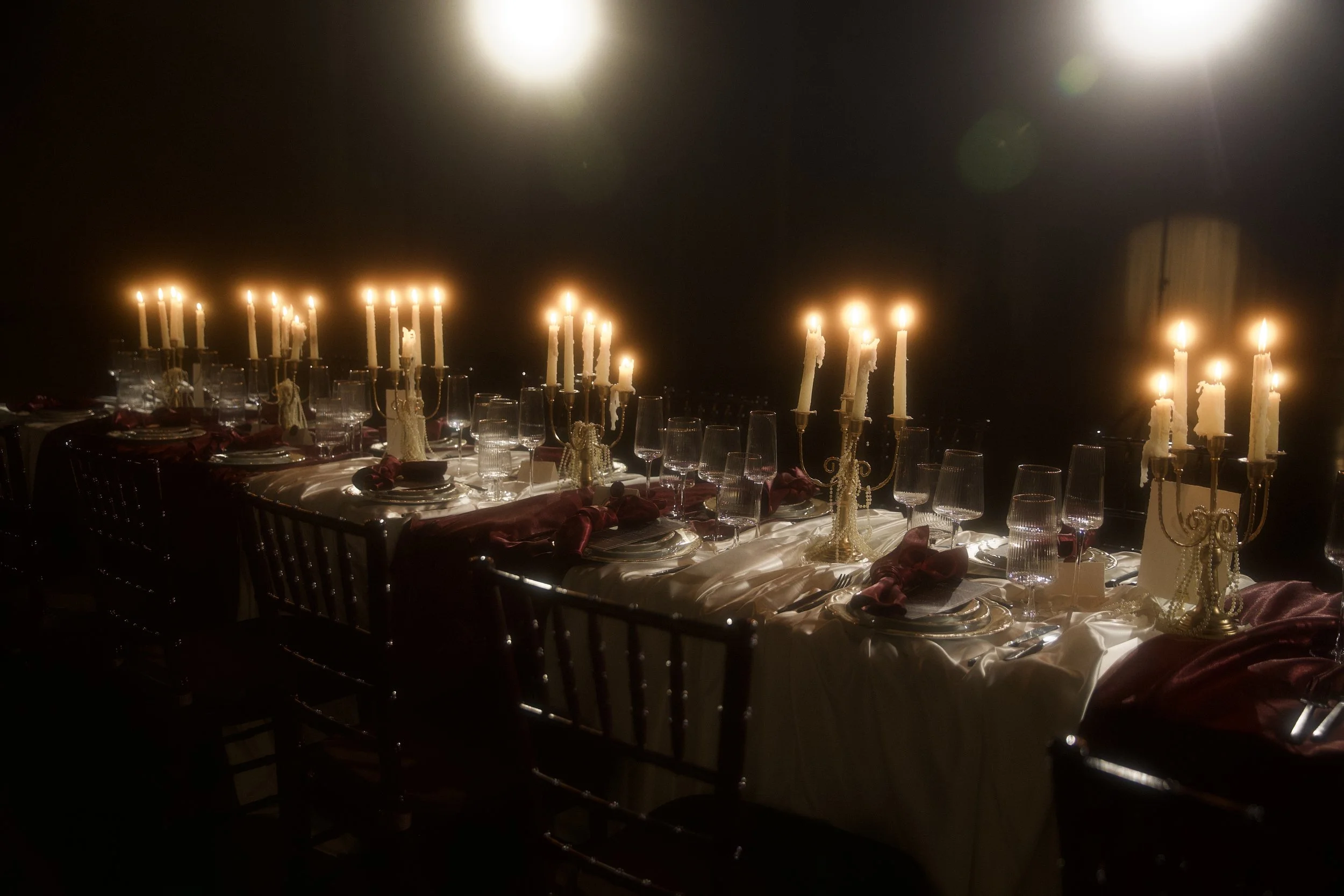 A dramatic  floral installation featuring deep red roses, burgundy blooms, cascading amaranthus, and layered candlelight. Designed by S.R. Event Design & Decor for a dark romance styled shoot at Bella Sera Event Villa near Pittsburgh, this statement 