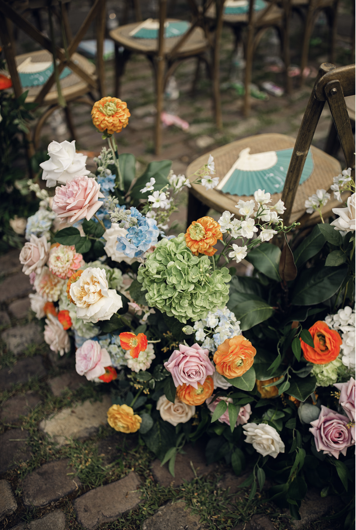 A picture-perfect Cleveland wedding ceremony framed by premium silk flowers and a historic garden fountain