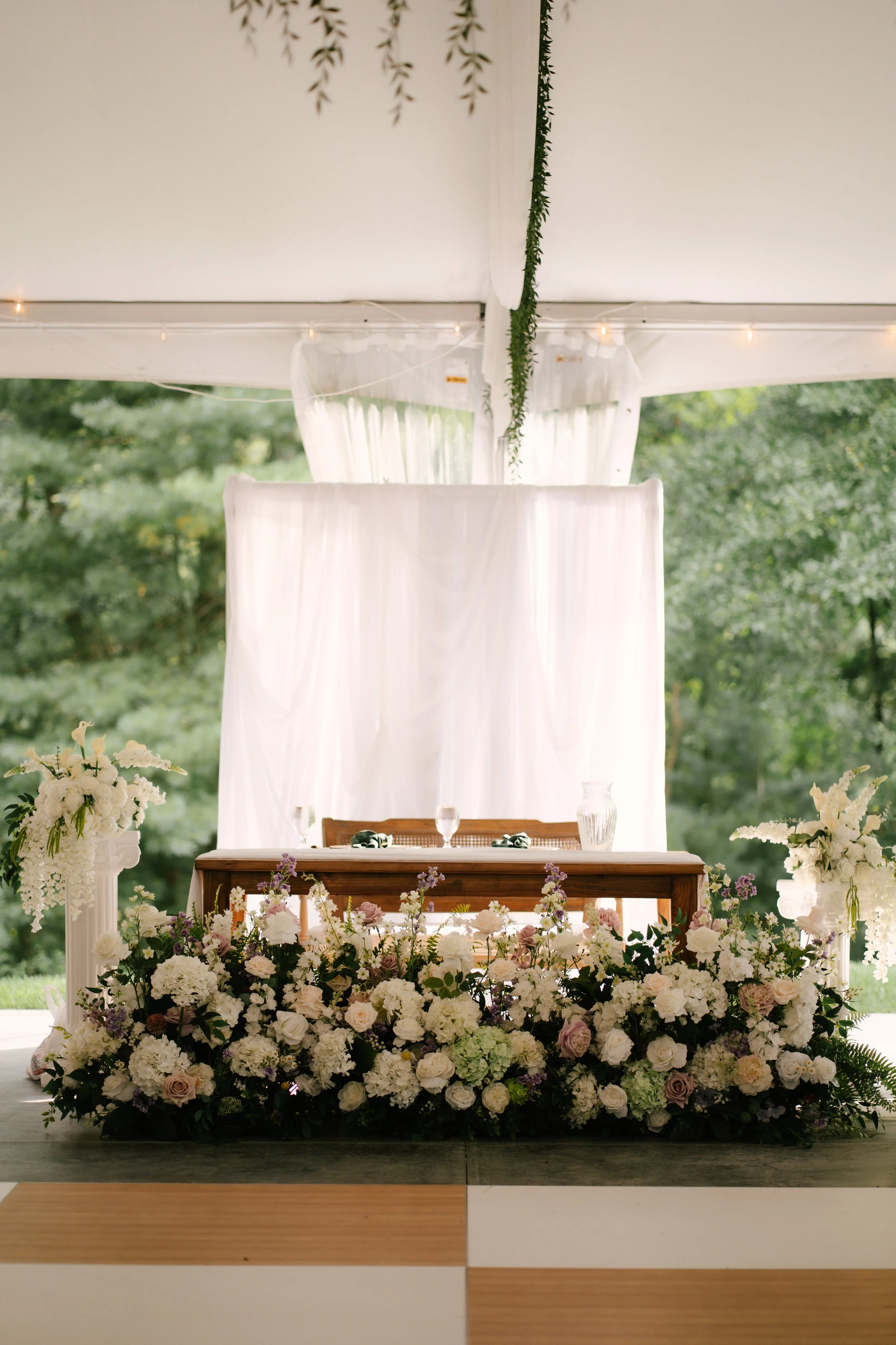Beautiful Full Floral Meadow built custom for the Couple , in ivory , cream and purple accents . Our Floral Meadow can be transitioned from Ceremony to Reception Photo : Fabus Photo & Film 
Venue : Trillium Woods 
Coordinator/ Planner : S.R Event Des