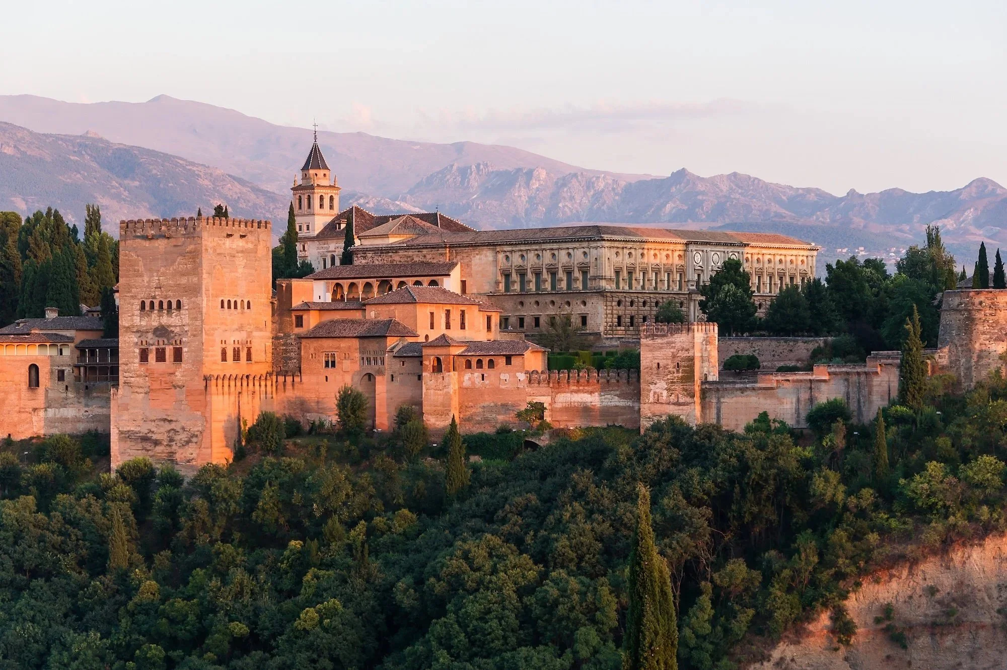 Alhambra palace and fortress complex in Granada, Spain framed by the Sierra Nevada mountains