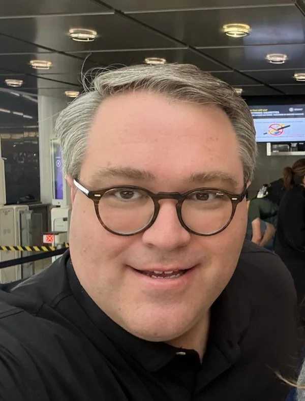 Kyle Priddle in the gate area at JFK airport, getting ready to fly to Paris
