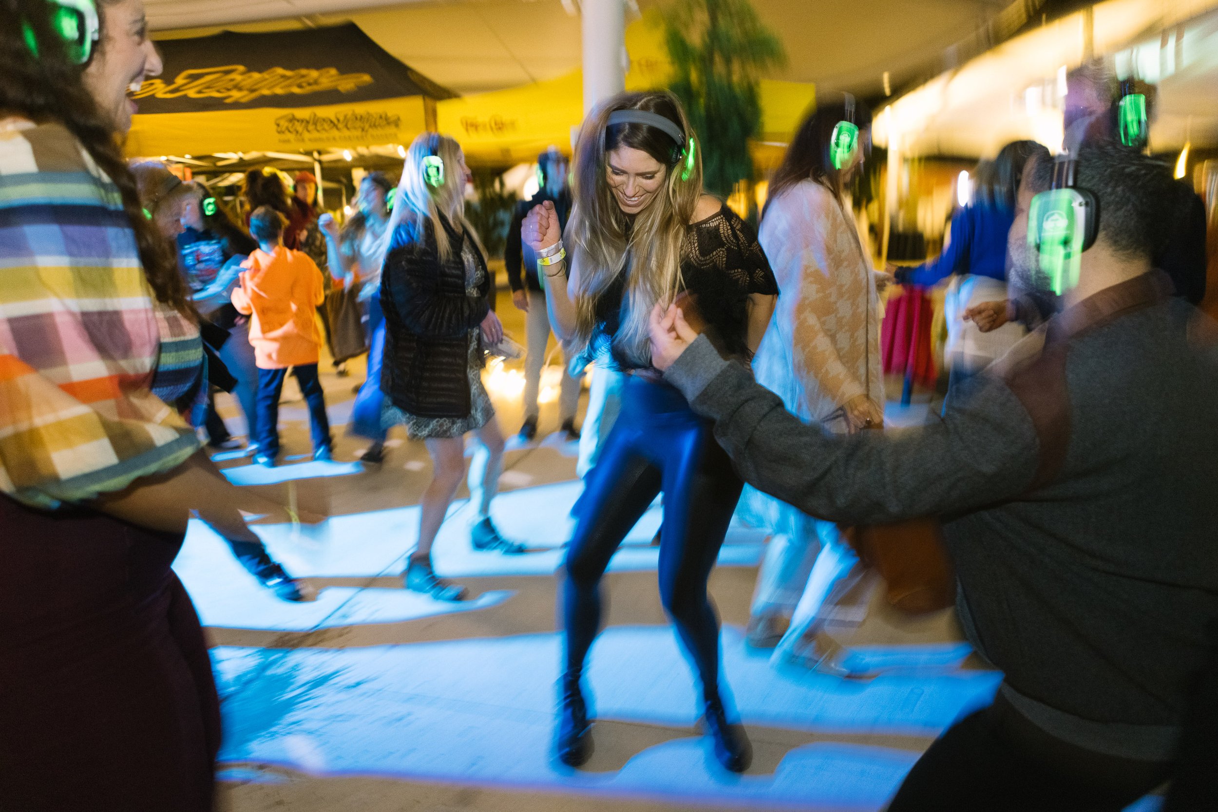 ladies dancing the night away at a silent disco party at coast film & music festical