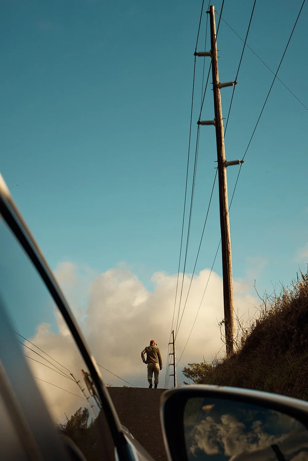 CostaRica_ManWalking_Road_CarMirror_Cloud.jpg