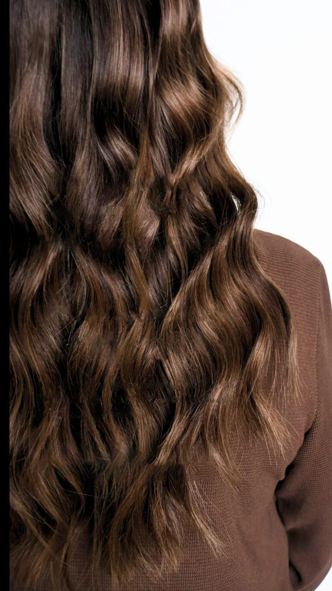 Back view of woman with long brown hair extensions