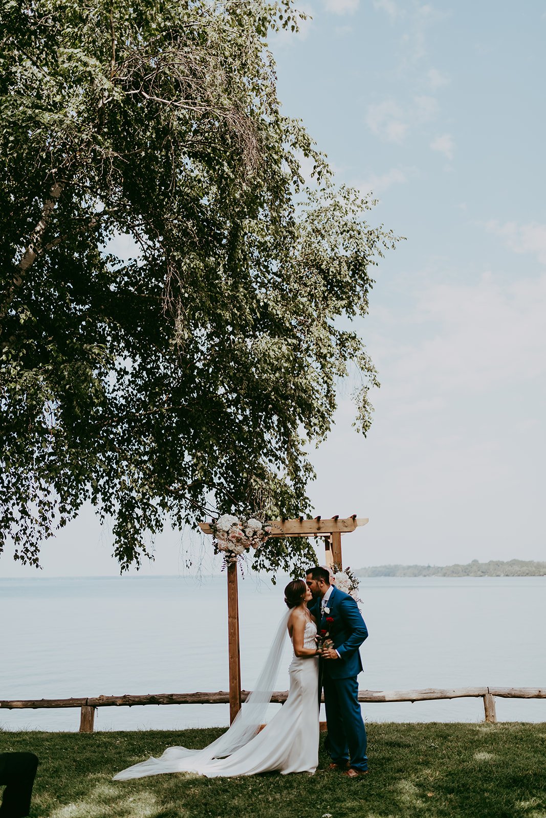 the-briars-resort-and-spa-outdoor-july-summer-wedding-toronto-ceremony-first kiss.jpg