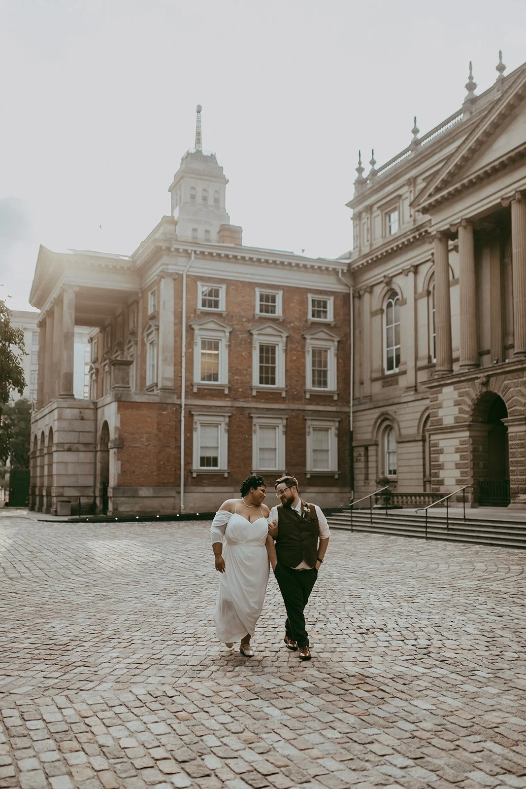 Wedding couple walking at Osgoode Hall in Toronto.