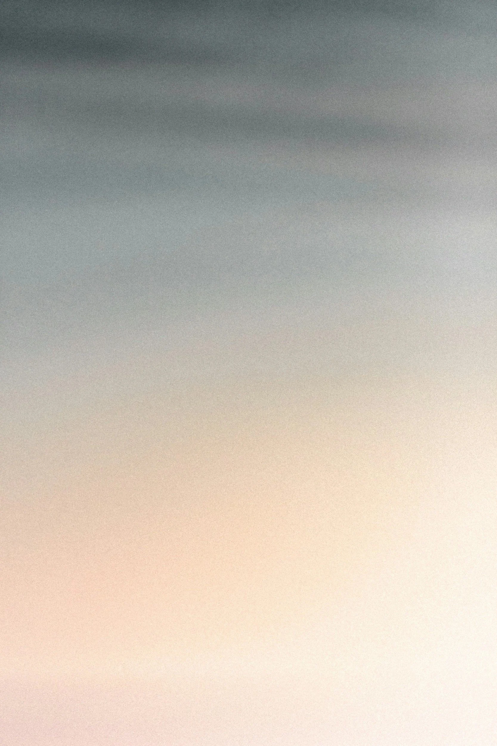 A gradient sky transitioning from blue to light orange at sunset