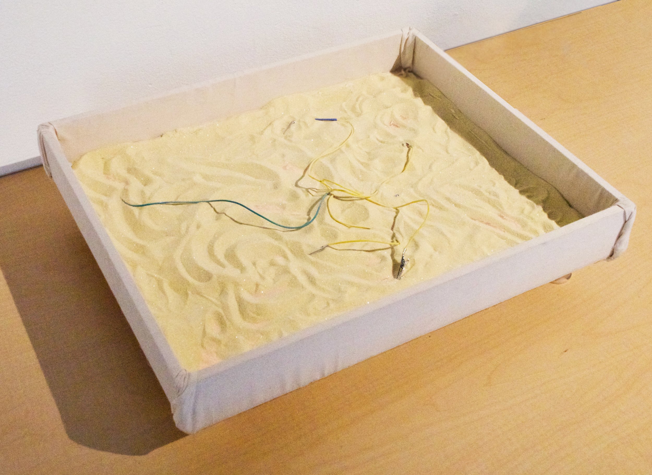 Warming Sandbox (2022)
Aduino Uno, touch capacitors, 12 volt heating pads,
wood, canvas, and crafting sand
This project is a working prototype for a sandbox
that warms where the user touches, recreating the
personalized, nostalgic warmth of a playgro