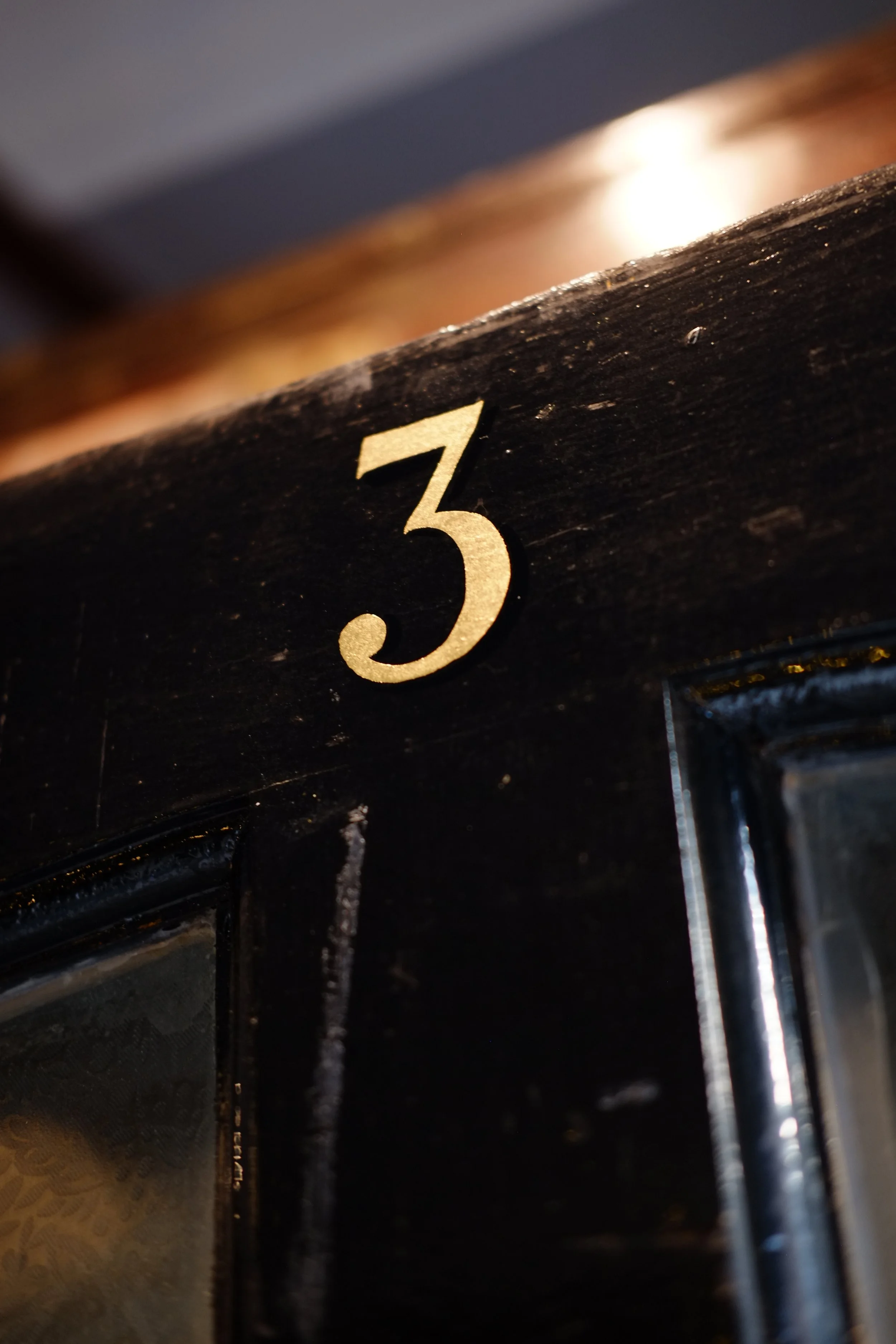 A gold leaf number for a door