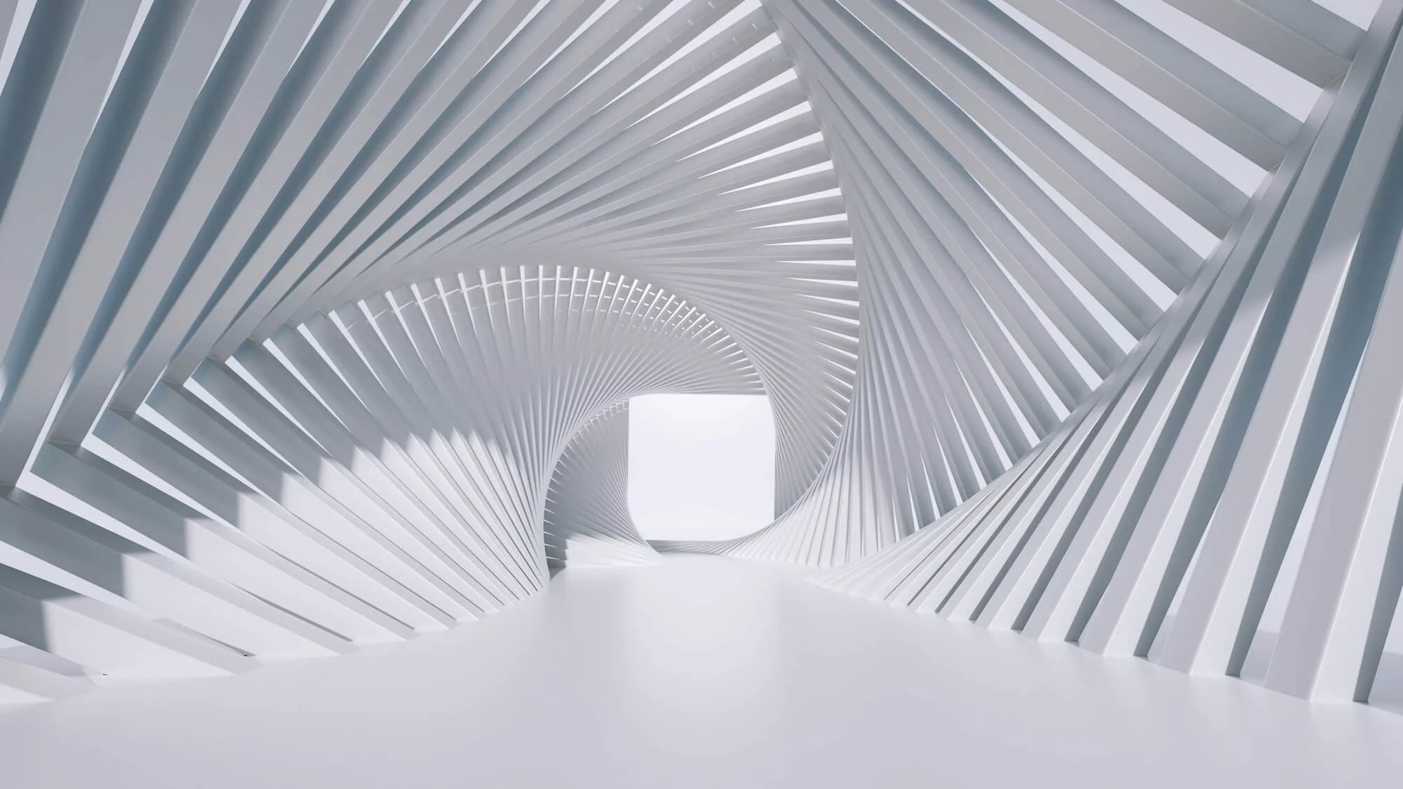 A modern architectural corridor with white curved, slatted walls creating a spiral tunnel effect, ending in a bright square opening.