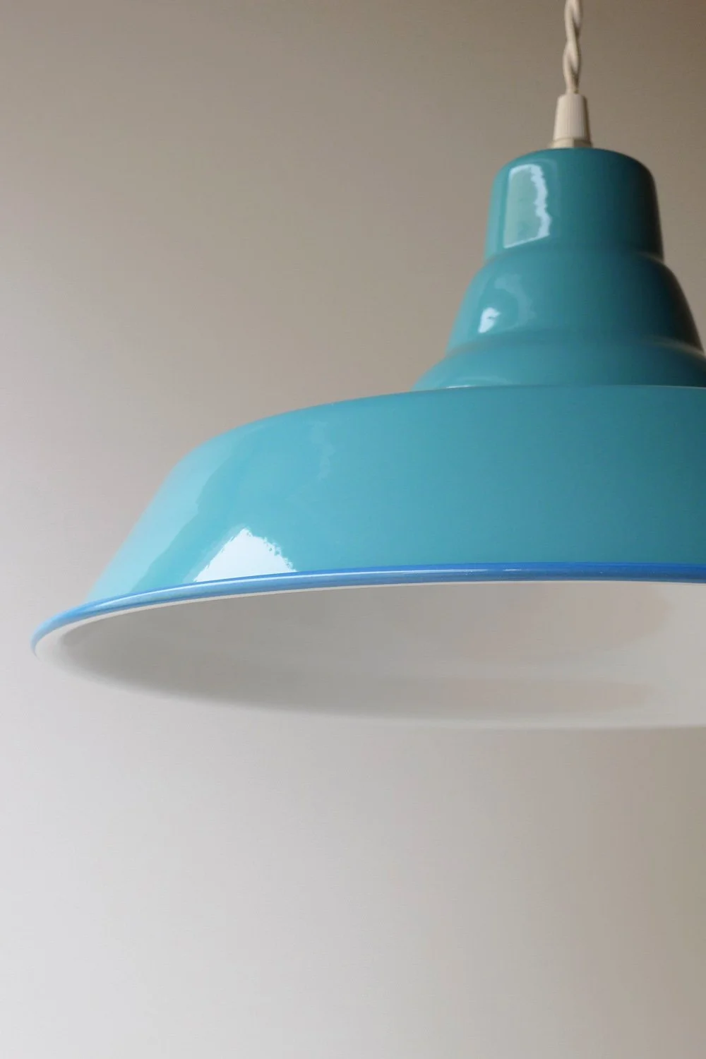 Close-up of a blue pendant light fixture hanging from the ceiling.