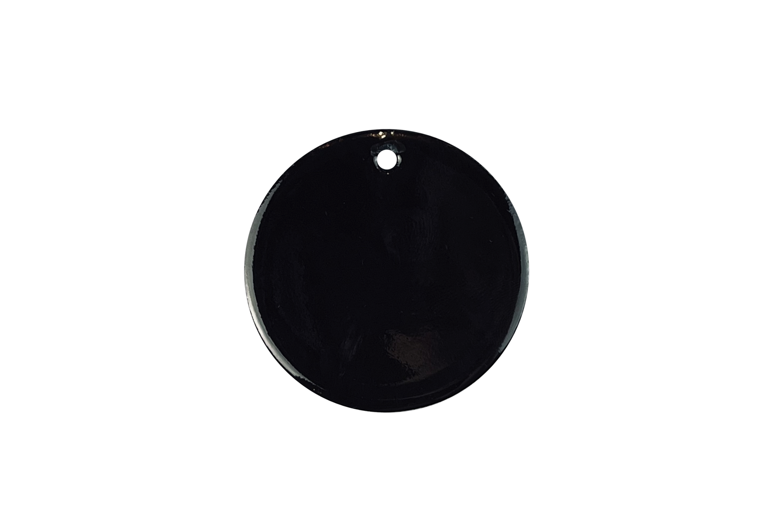 Close-up of a black circular enamel sample with a hole on the top edge, set against a white background.