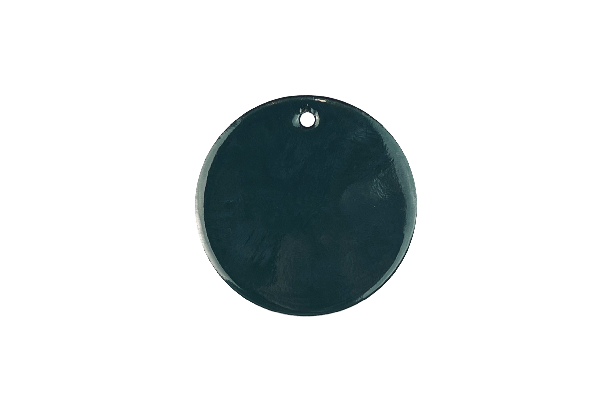 Top of a dark green or black kettle with a small round hole at the top, isolated against a black background.