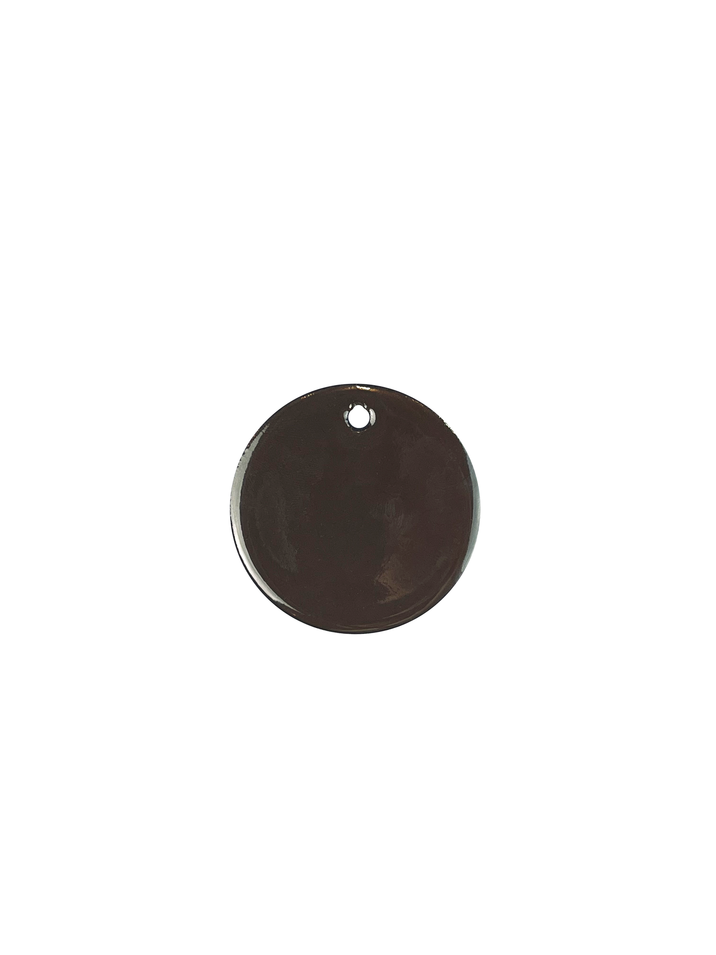 A round black enamel sample object with a small hole near the top on a white backgorund.