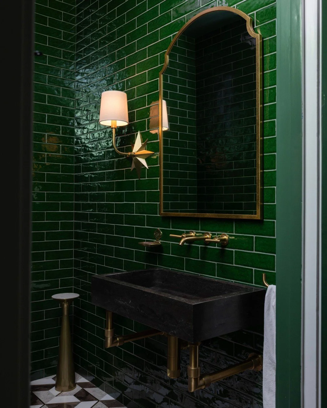 A powder room cast in an emerald glow, tiptoeing into an alternate universe. ⁠
⁠
Our latest renovation, Snug House, is coming soon. Until then, we're sharing the corners we adore. ⁠
⁠
XKED⁠
⁠
Interior Design by @stassije, @kristenelizabethdesign⁠
Pho