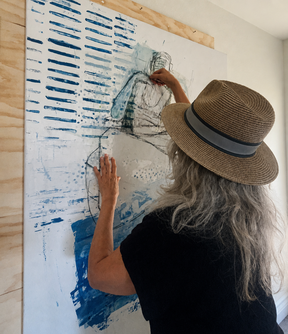 Kathleen working on a large figurative painting in the studio.