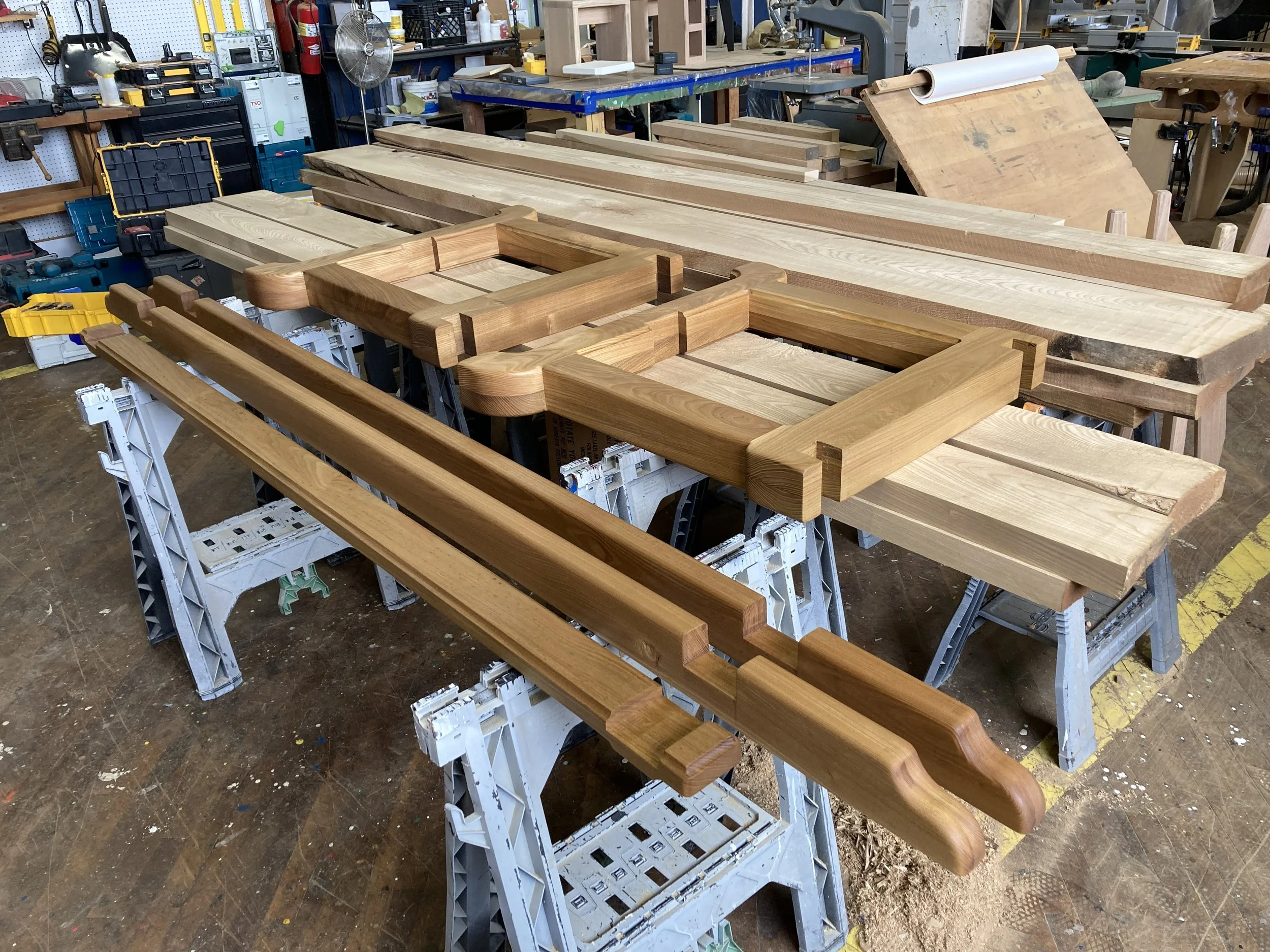 Wooden pieces on sawhorses in a workshop