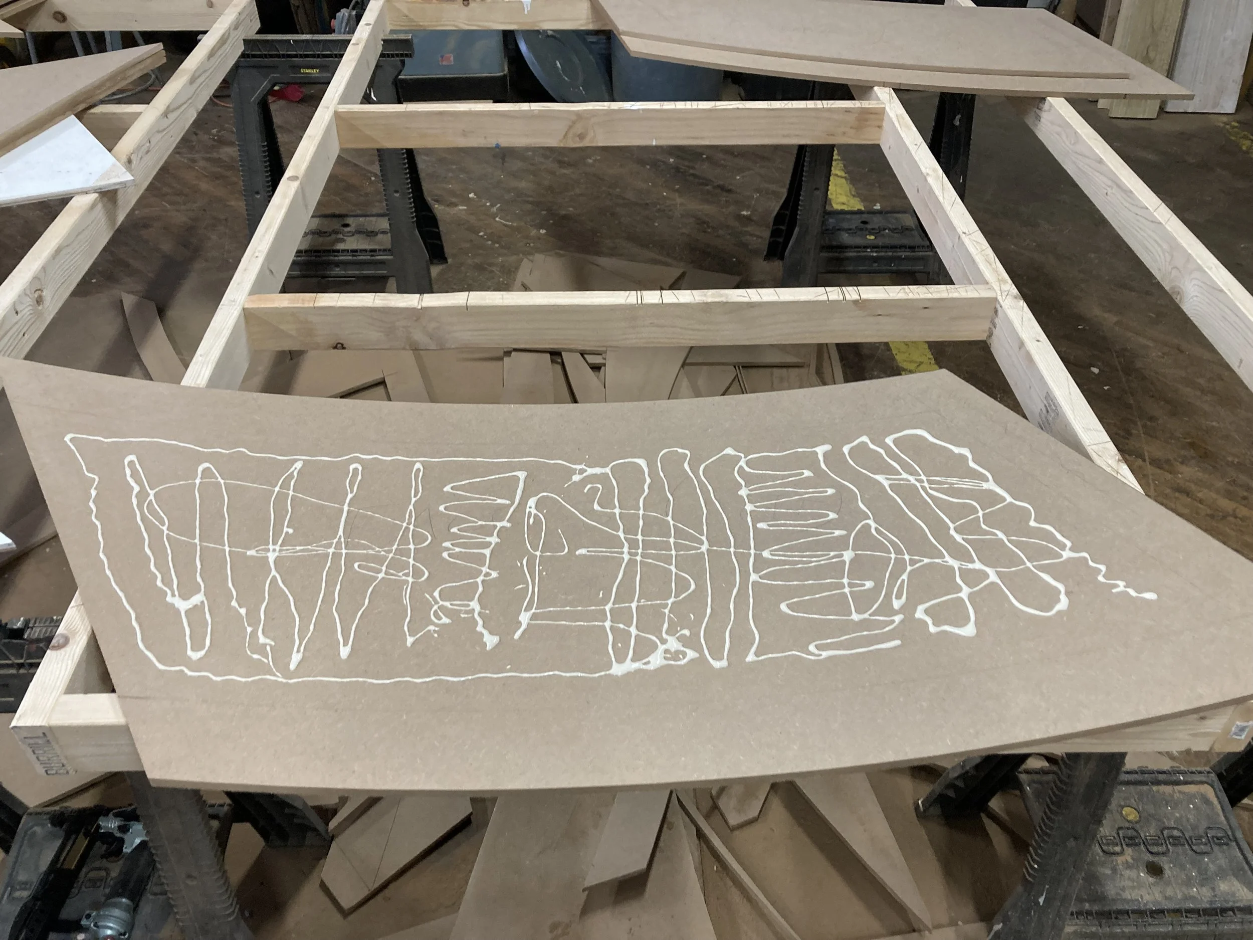 Woodworking project with wooden frame and a panel being glued.