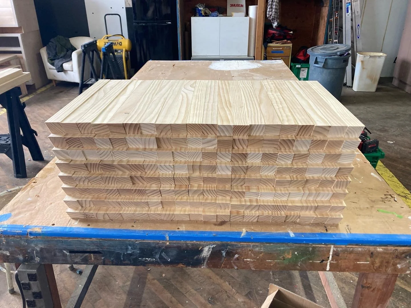 Stack of wooden boards on a workbench in a workshop