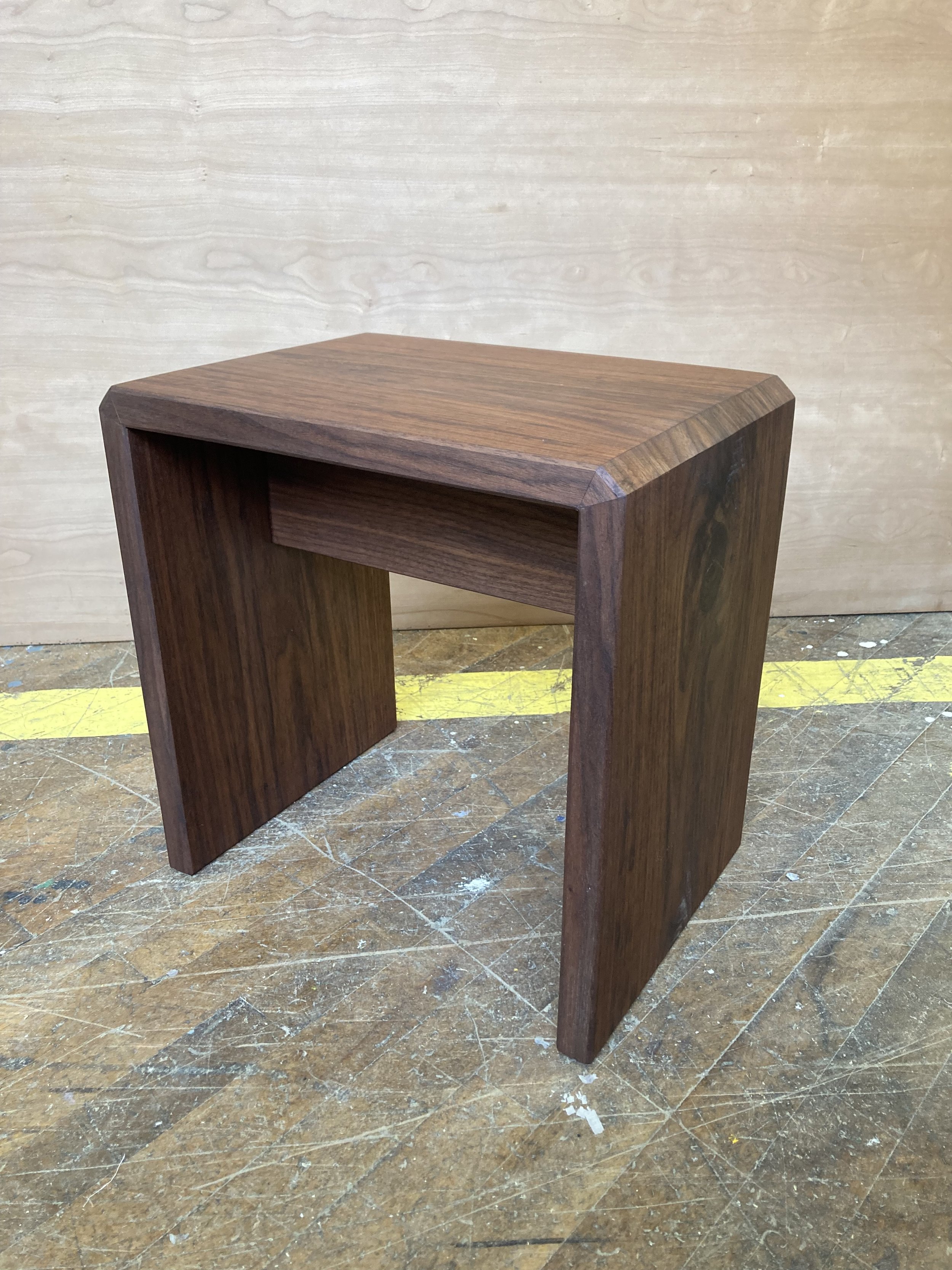 Small wooden stool on a workshop floor