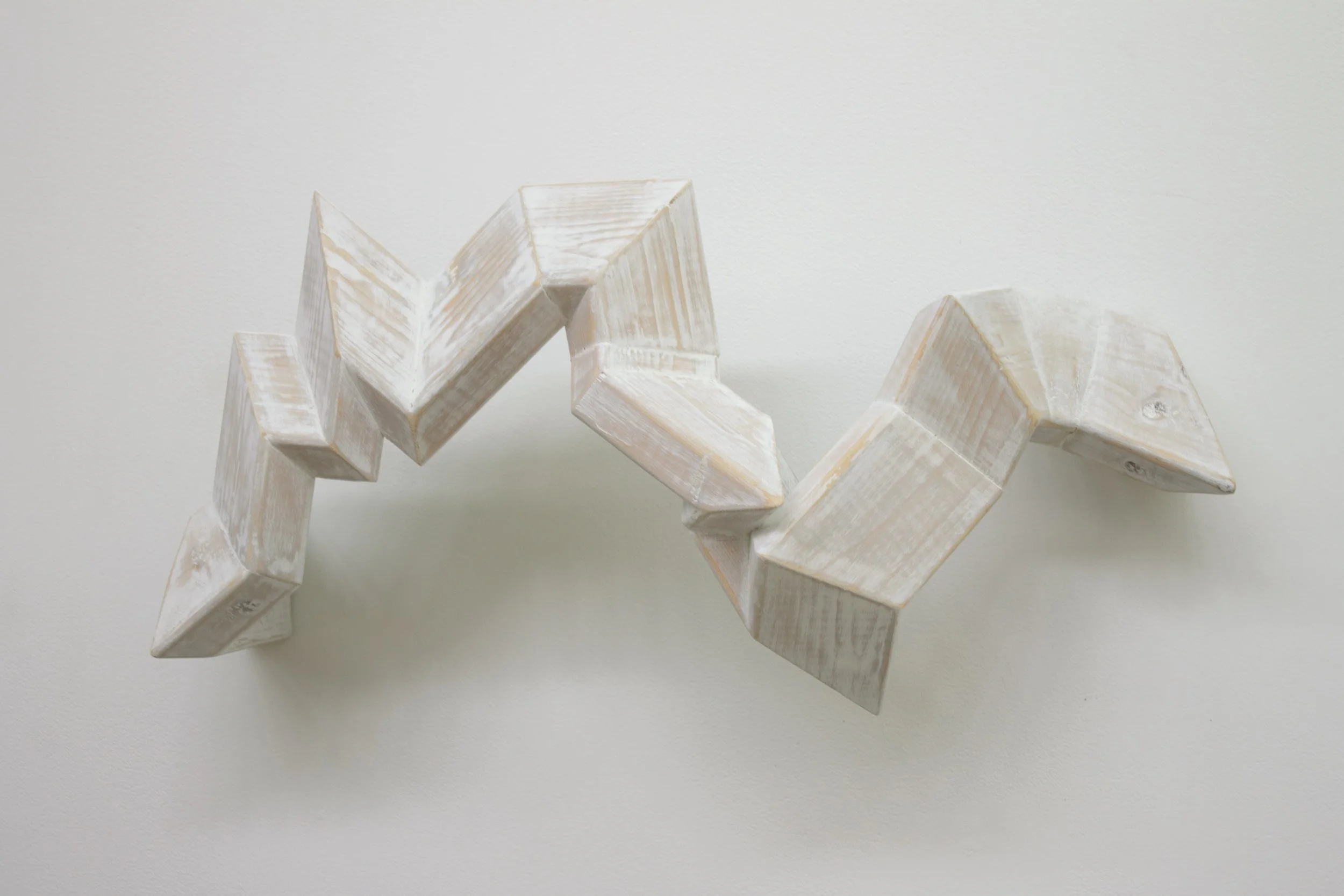 Abstract geometric sculpture on wall