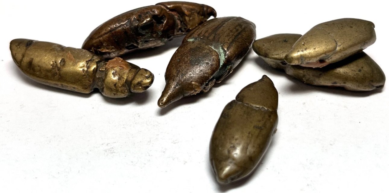 Six Akan beetle gold weights cast from nature.