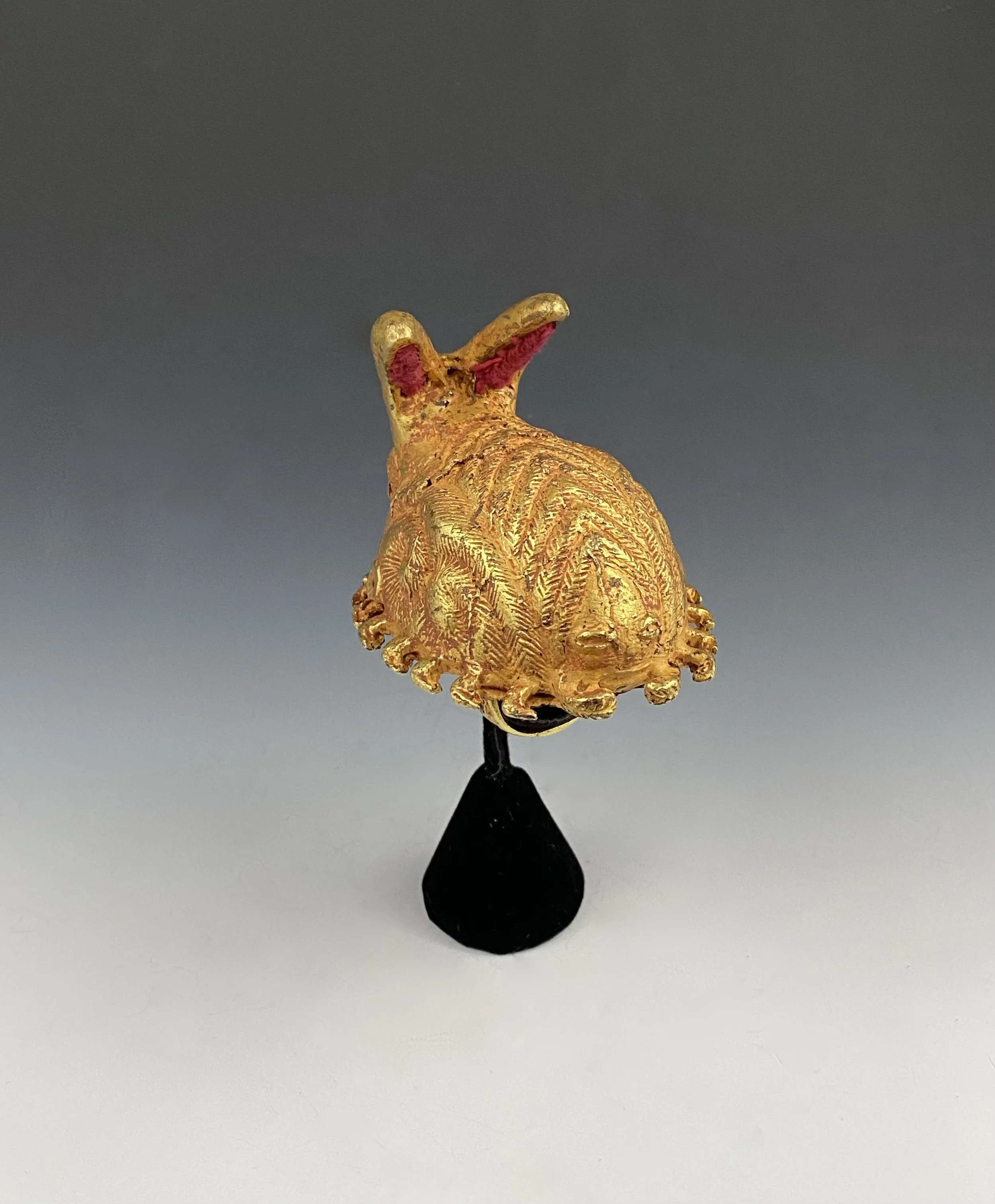 This colossal Asante chief’s ring "mpetea" in the form of a scorpion is the largest in the collection. Its exceptionally large size and material emphasized the importance and power of its owner. Cast high karat gold, 3" L × 2 1/4" W × 3" H. 112g. One
