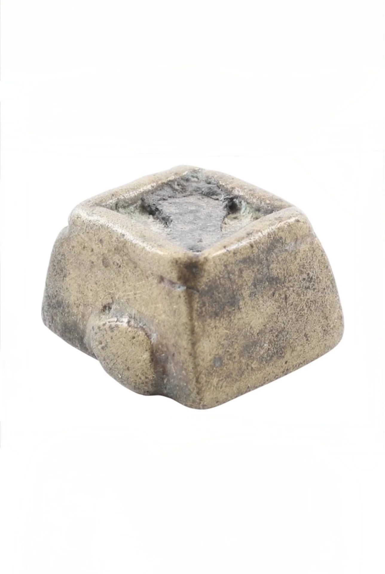 An Akan copper alloy gold weight in a truncated pyramid form with a recessed top inset with lead for weight adjustment. 1/2" square, Ghana. Ex Sir Cecil Armitage Collection, dating to the second half of the 19th century to early 20th. Sir Cecil Armit