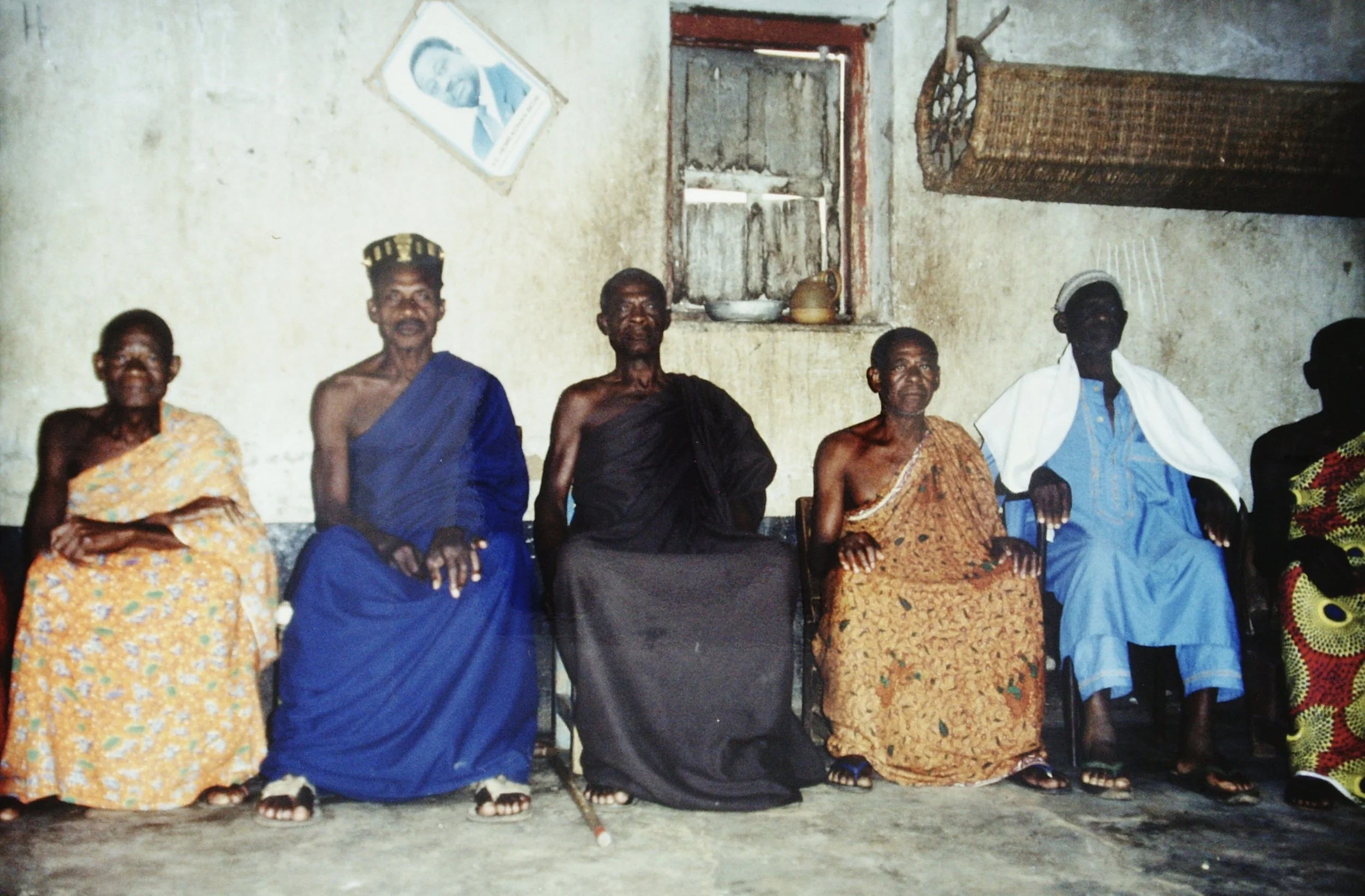 The chief of Essikro with his council of elders, Côte d'Ivoire, 1999.  The notable photo on the wall is of President Bedié who was overthrown by a coup weeks later.