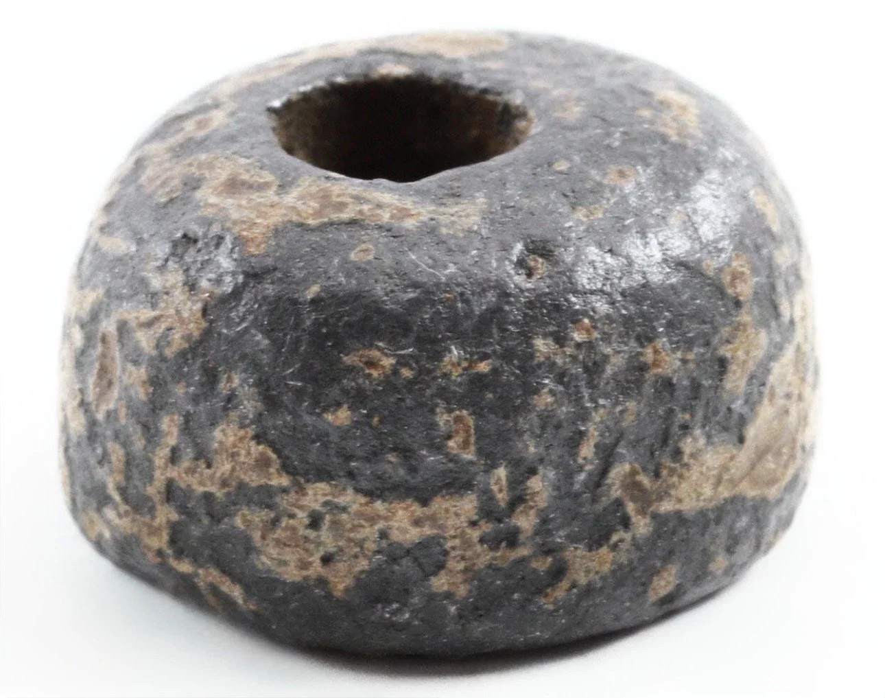 An Akan gold weight with a center hole.  This weight has a heavily aged patina and shows signs of its age and use. 
Ex Sir Cecil Armitage Collection. Dating to the second half of the 19th century to early 20th. Sir Cecil Armitage, Governor of Gambia 