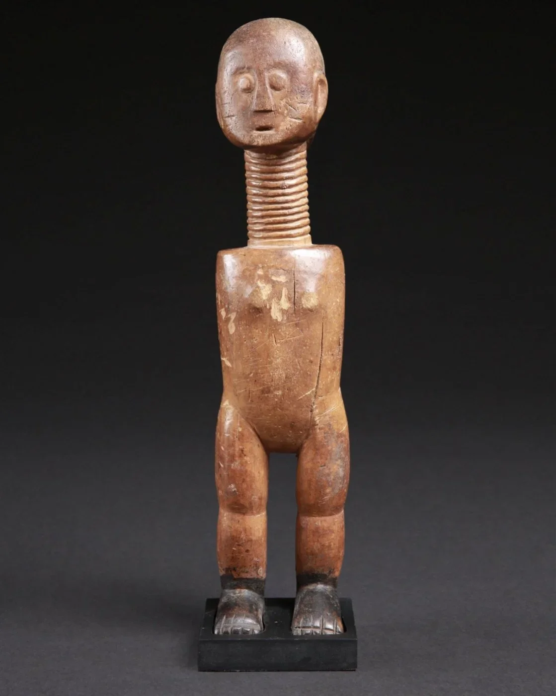 Fanta figure, Ghana. Wood. H 32cm. W 7cm. Standing female figures are common in West Africa and their symbolism and tasks are interpreted in many ways. In the matrilineal society of the Akan, self-confidence, grace, composure, dignity, stability, poi