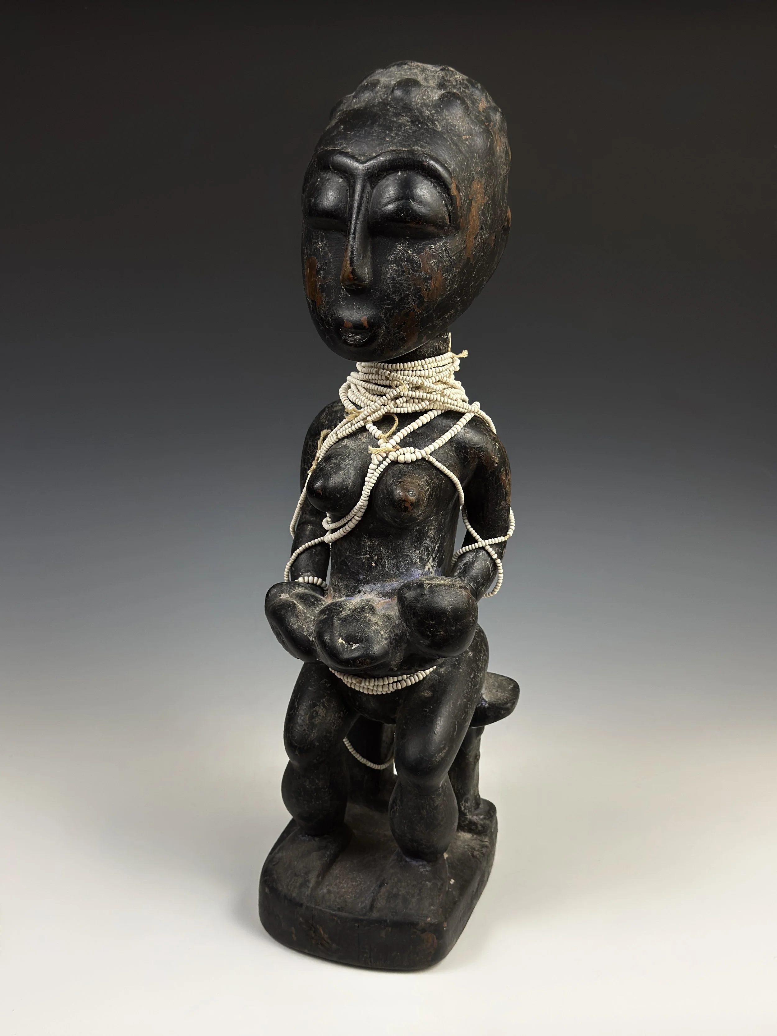 
An Abron (Akan) maternity figure. Ghana. 17.5" H. Carved wood, brass tacks, pigment, glass beads. Abron maternity figures are relatively rare in comparison to the neighboring Baule in Côte d'Ivoire. Ex collection of Dr. Arikana Chihombori-Quao and D