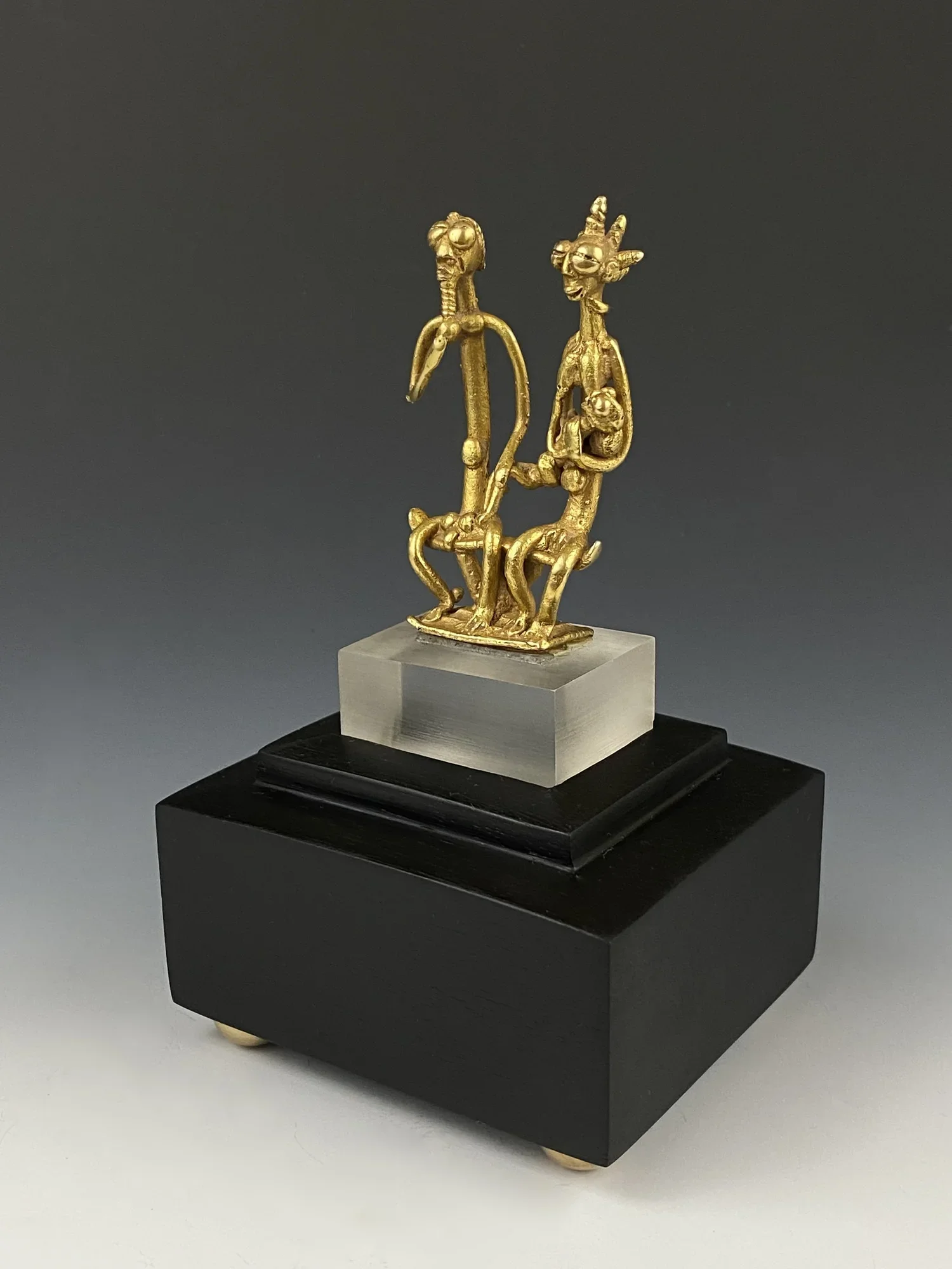 One of the rarer objects in the collection is an exceptional, fine Asante or Baulé “royal” gold weight or prestige object, Ghana/ Côte d’Ivoire. While gold weights are commonly cast in bronze, this special object of great prestige is cast in yellow g