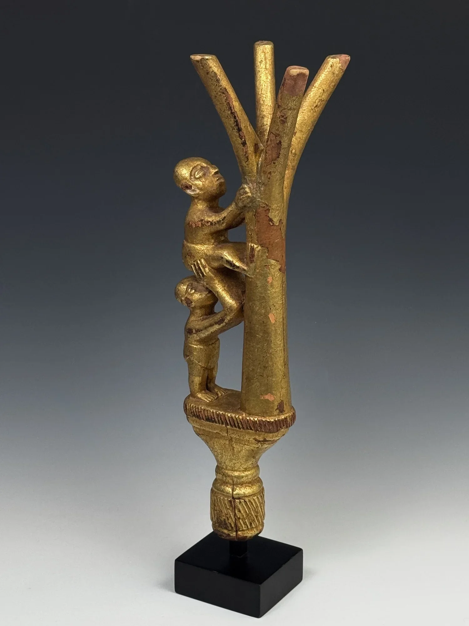 An Ashanti linguist staff finial (okyeame poma). Ghana. The finial depicts a tree with one figure helping another to climb it. Ht. 16 in. It depicts the saying, "If you climb a good tree, you get a push," or if your intentions are good, people will h