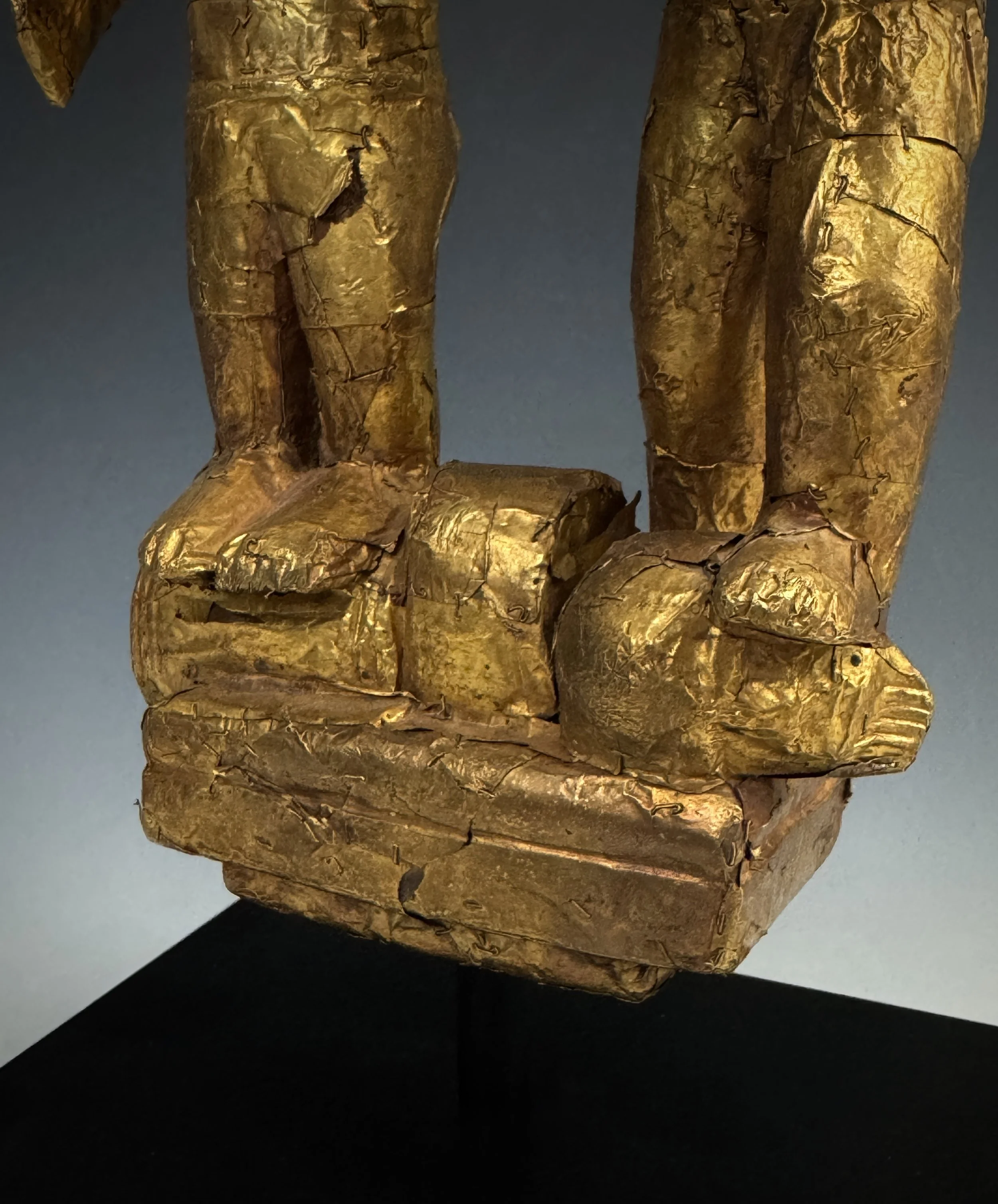 In this example we see the severed  head under the foot of the right figure.
