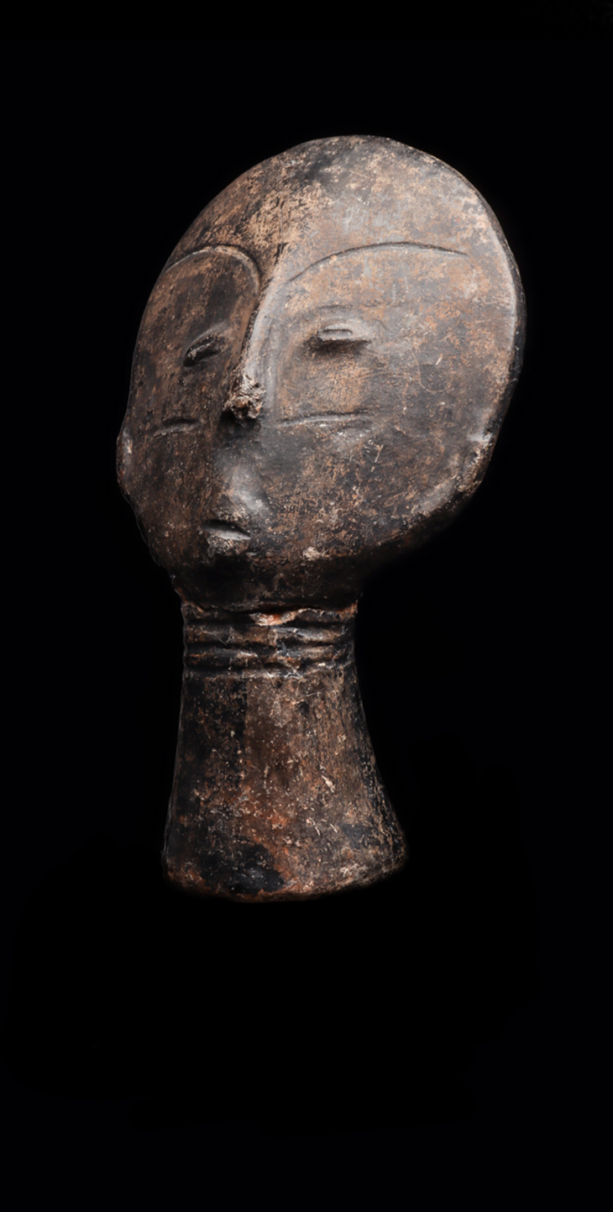 Akan terracotta memorial head (Mma)(Nsodie), Ghana. Idealized heads were made by woman posthumously to honor and commemorate the individual after death. 7.5” H. Terracotta, pigment, break and repair at neck. Provenance: Howard S. Rose Gallery, NYC. F