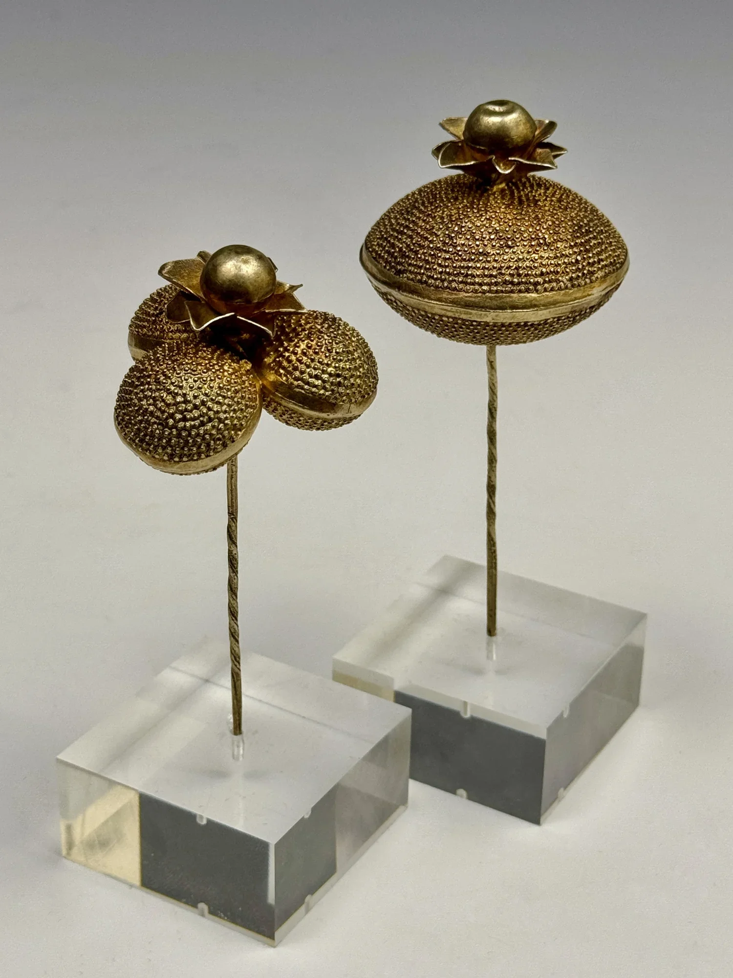 Two Akan (Fante) fabricated gilt silver/silver-gold alloy hairpins with a floral pattern (Victorian style), 2” dia, Ghana. “Many Victorian motifs and patterns are still being reproduced in contemporary versions. The continuing interest in this design