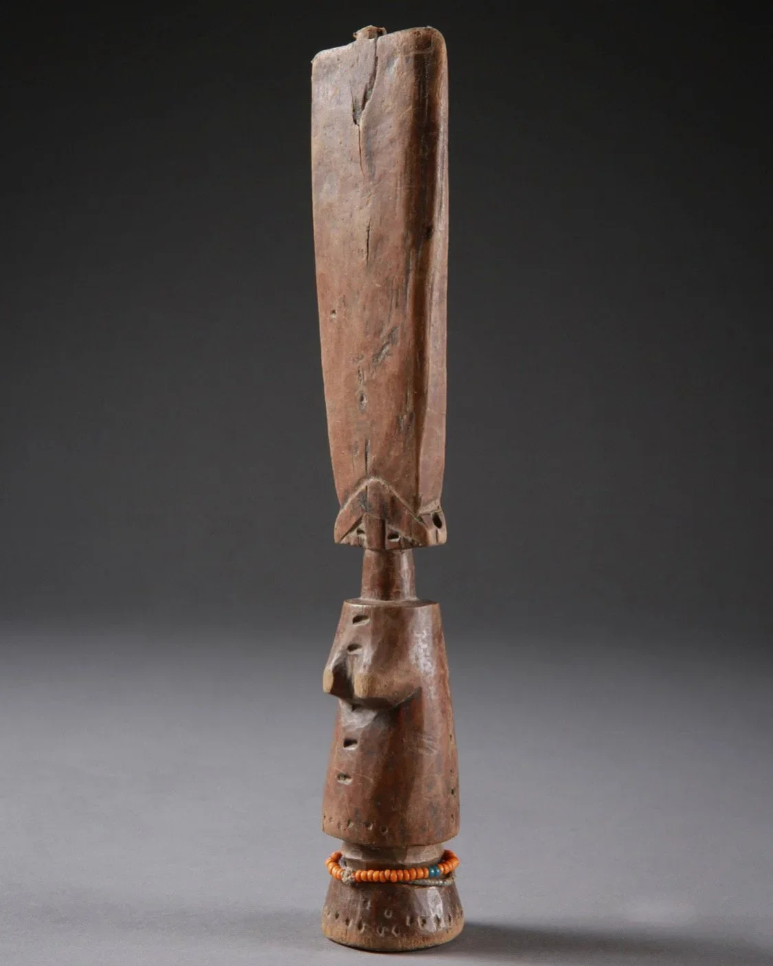 An Akan (Fanta) “Akuaba” fertility figure, Ghana. Wood, glass beads, 26cm. “The name Akuaba comes from the legend of a woman named Akua who was distraught at being barren, for Akan women desire above all to have children. She took her problem to a pr
